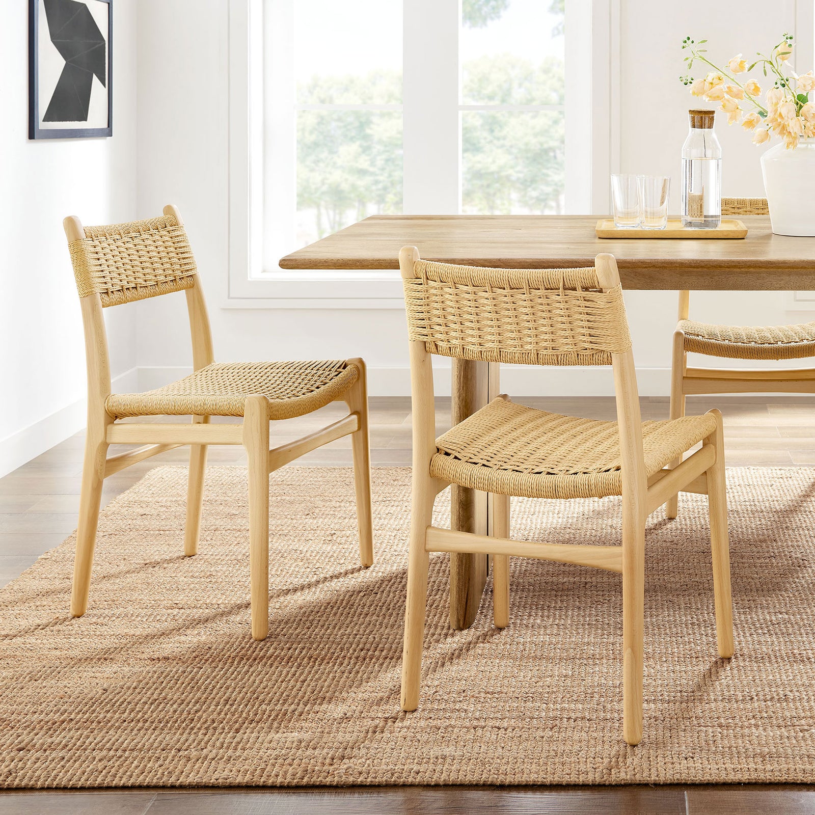 Pair of natural rope and wood dining chairs styled around a warm, modern farmhouse dining table. || EEI-7044-NAT-NAT || front_angle_multi_room