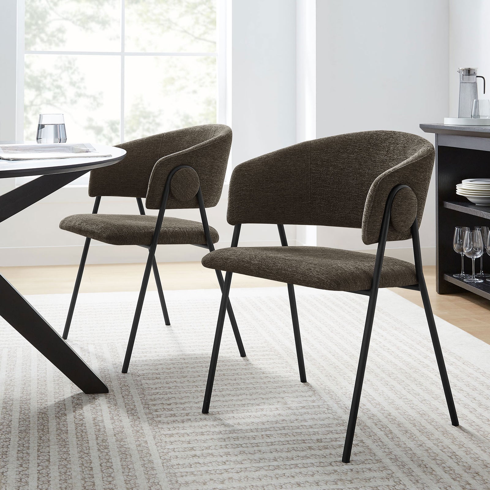 Pair of Nella java black dining chairs styled around a modern table in a bright dining room || EEI-7045-JAV-BLK || front_angle_multi_room