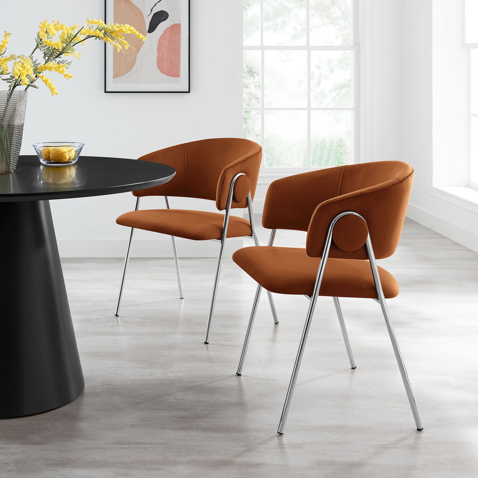 Pair of rust velvet dining chairs around a contemporary table in a sunlit room || EEI-7046-RUS-SLV || front_angle_multi_room
