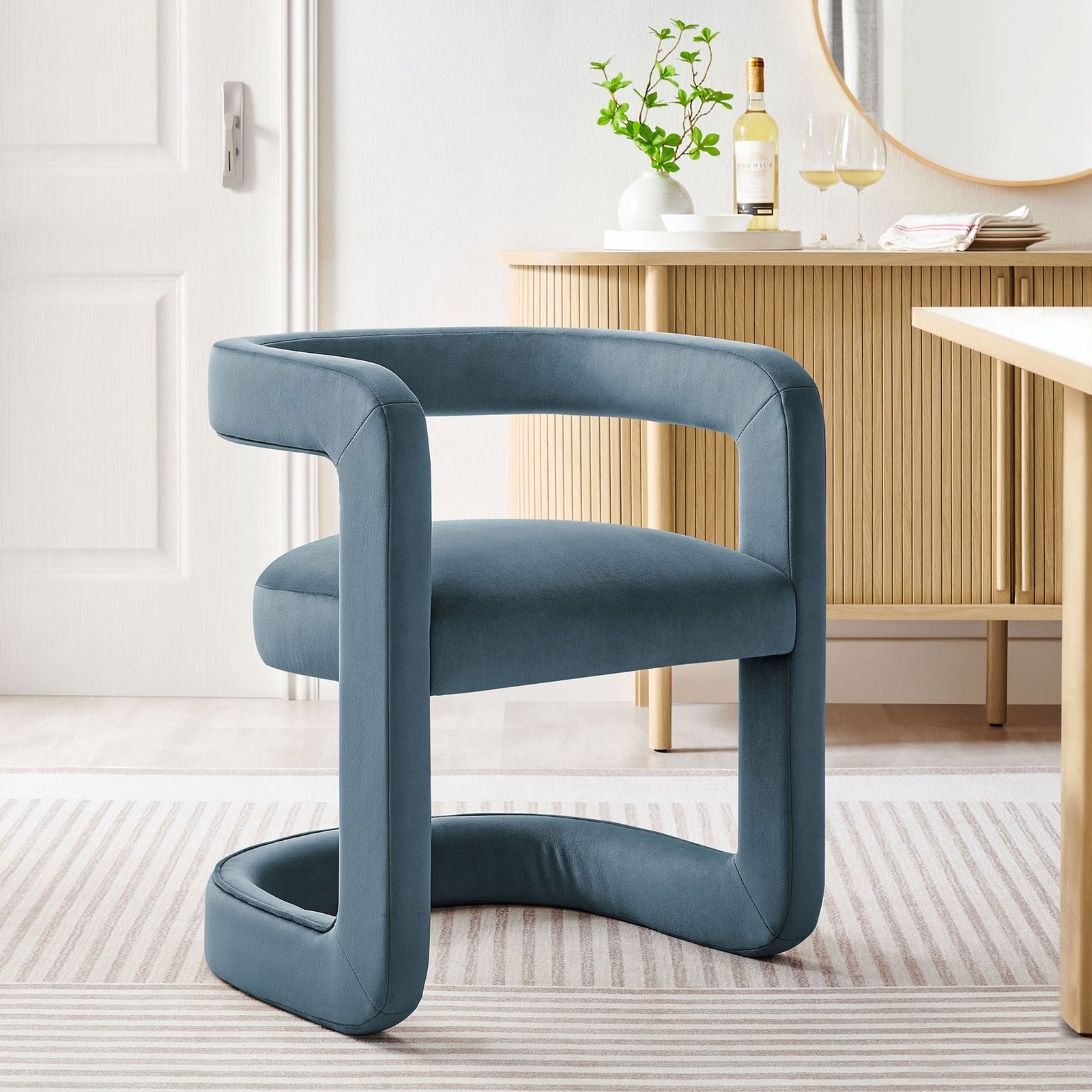 Cadet blue velvet barrel dining chair adding modern elegance to a light dining room with warm wood furniture || EEI-7052-CAB || front_angle_room