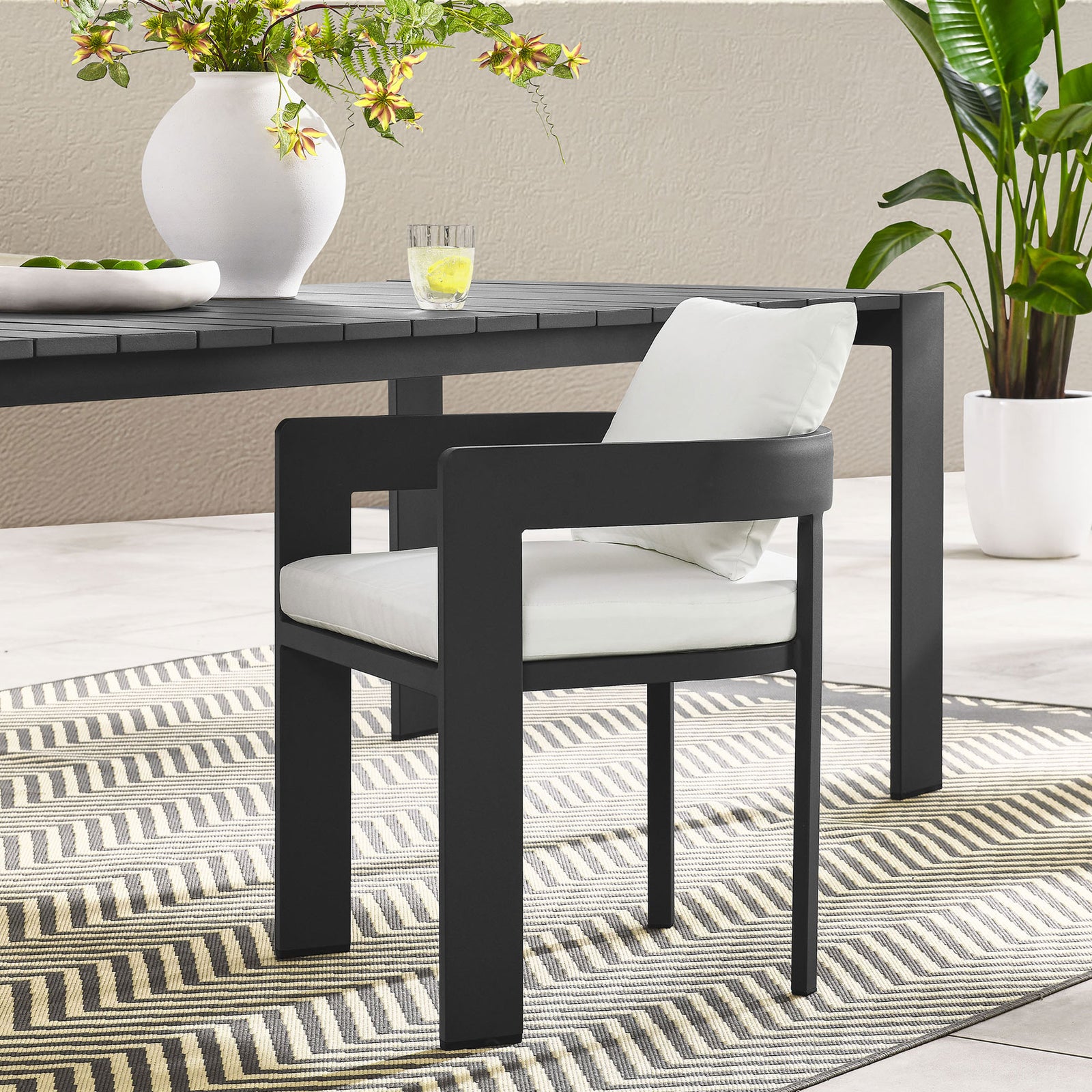 Charcoal Tahoe patio dining chair with white cushions styled around a modern outdoor dining table || EEI-7053-GRY-WHI || front_angle_room