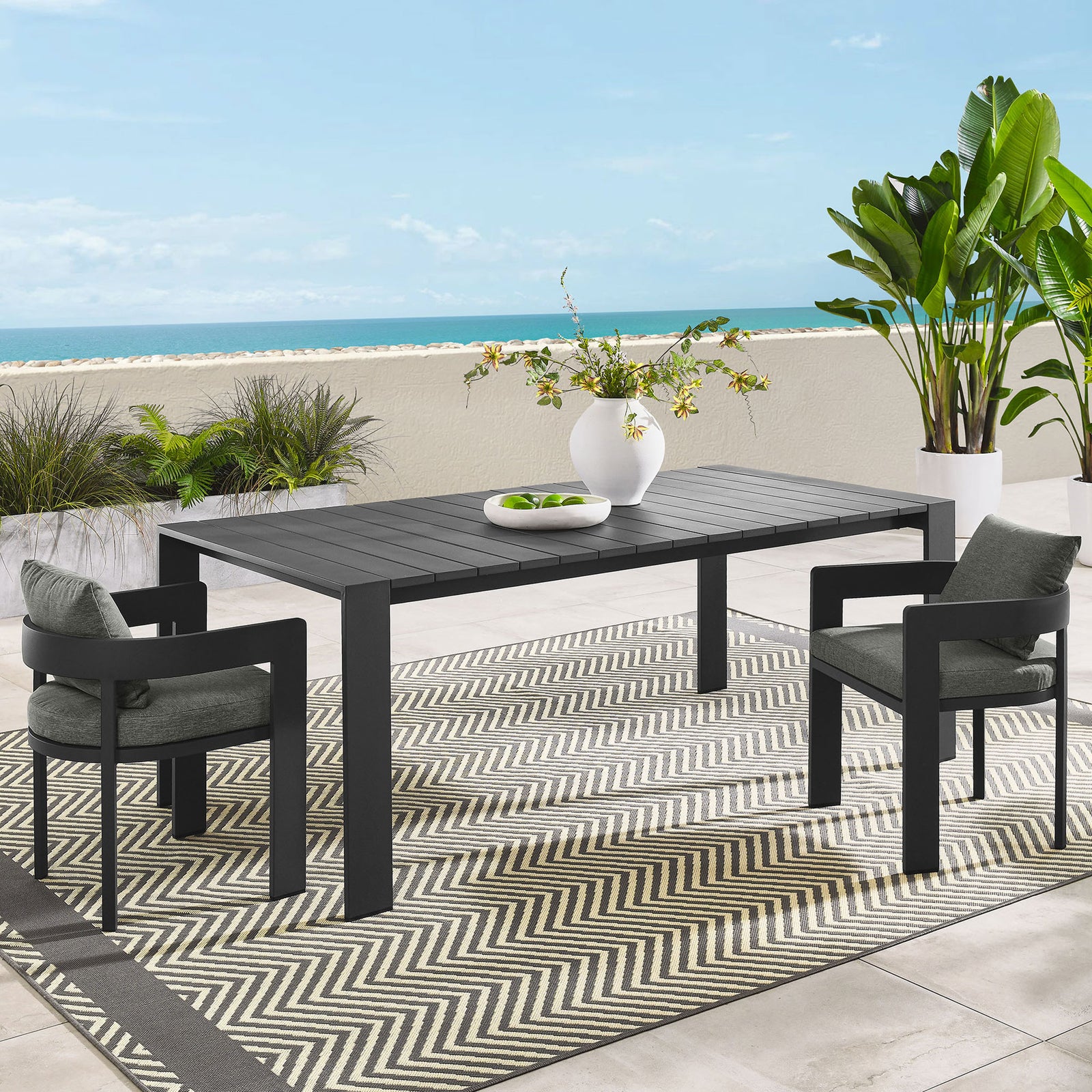 Tahoe patio dining table styled with modern chairs on a coastal terrace for eight-person meals. || EEI-7054-GRY || front_angle_room