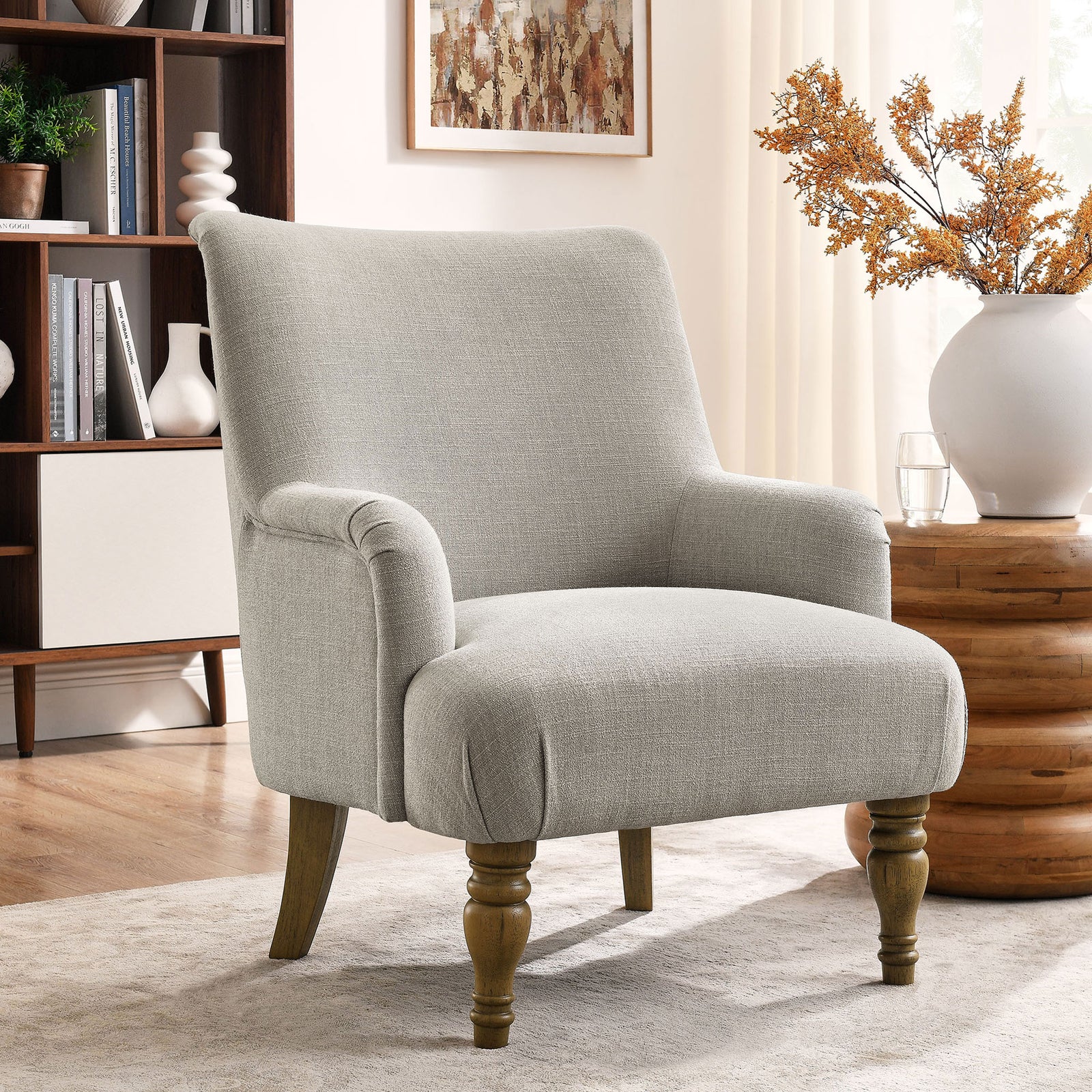 Linen-color accent chair elevates living spaces with plush comfort and classic wood legs || EEI-7057-LIN || front_angle_room