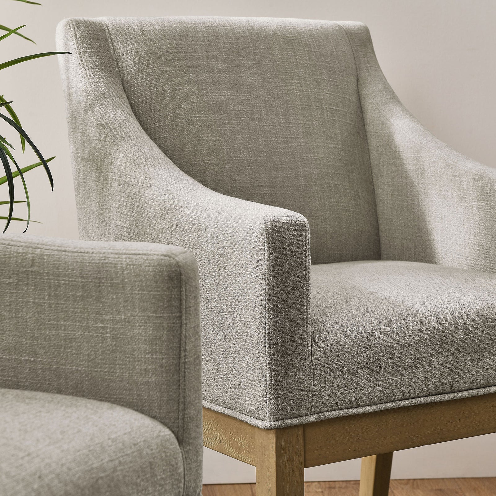 Pair of Alton linen armchairs bringing soft texture and warmth to a modern dining space || EEI-7058-LIN-NAT || front_angle_room