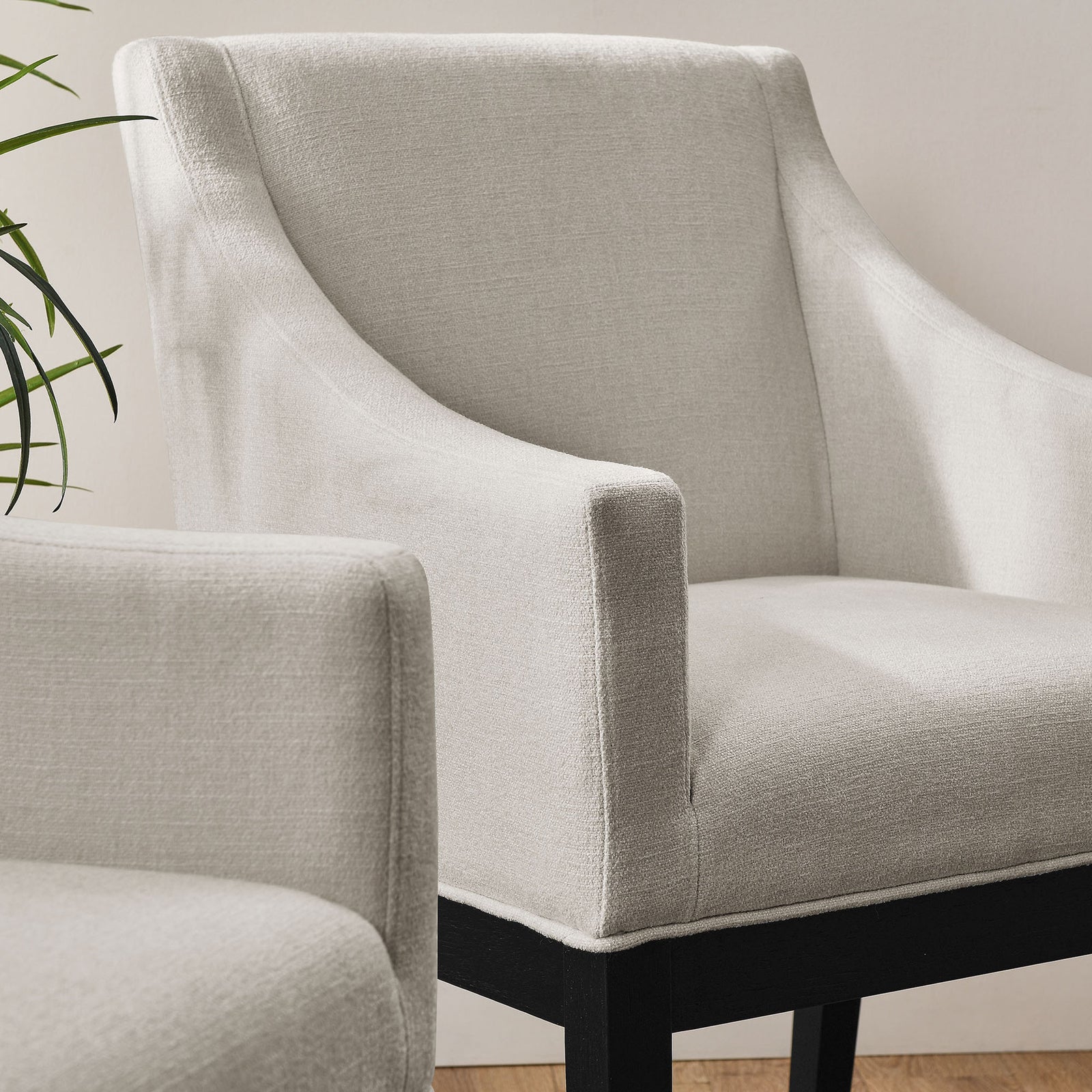 Alton upholstered dining armchairs bring inviting texture and comfort to a bright, modern room || EEI-7058-SAL-BLK || front_angle_room