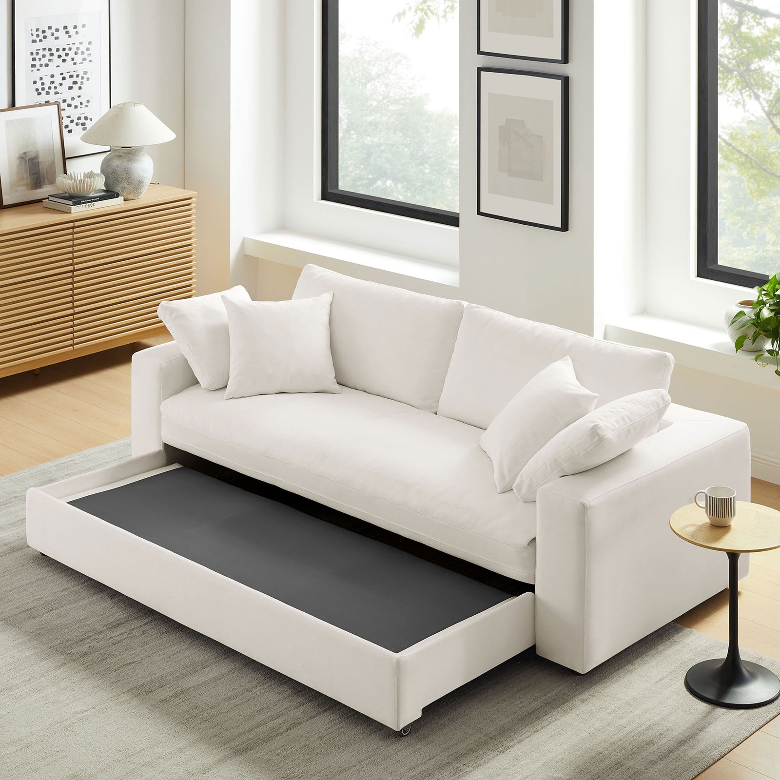 Living room scene with sofa base pulled out to reveal the first step of the sleeper conversion || EEI-7080-PUW || front_angle_converted_room