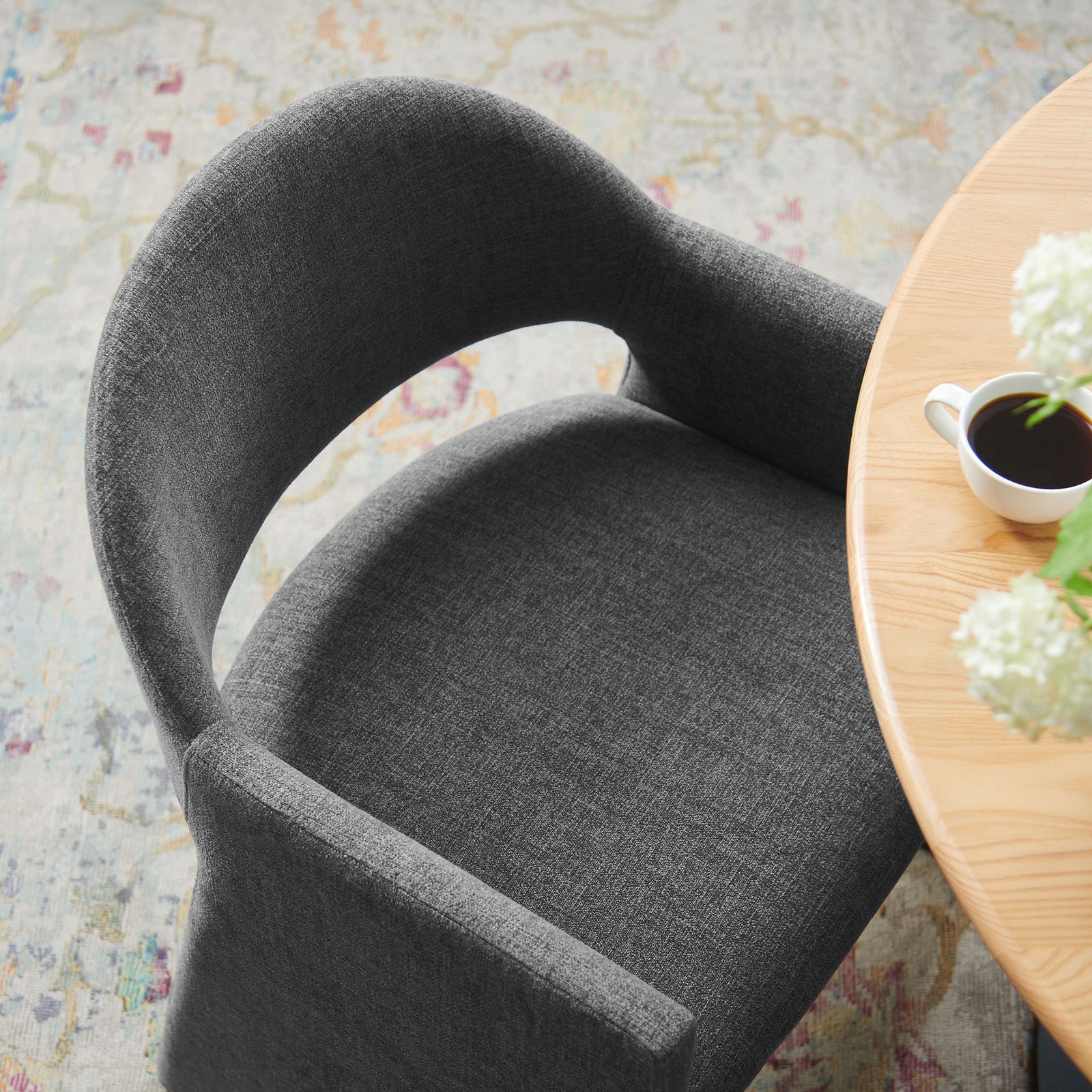 Charcoal barrel-back dining armchair tucked to a round table for a cozy modern setting || EEI-7082-CHA || detail_room