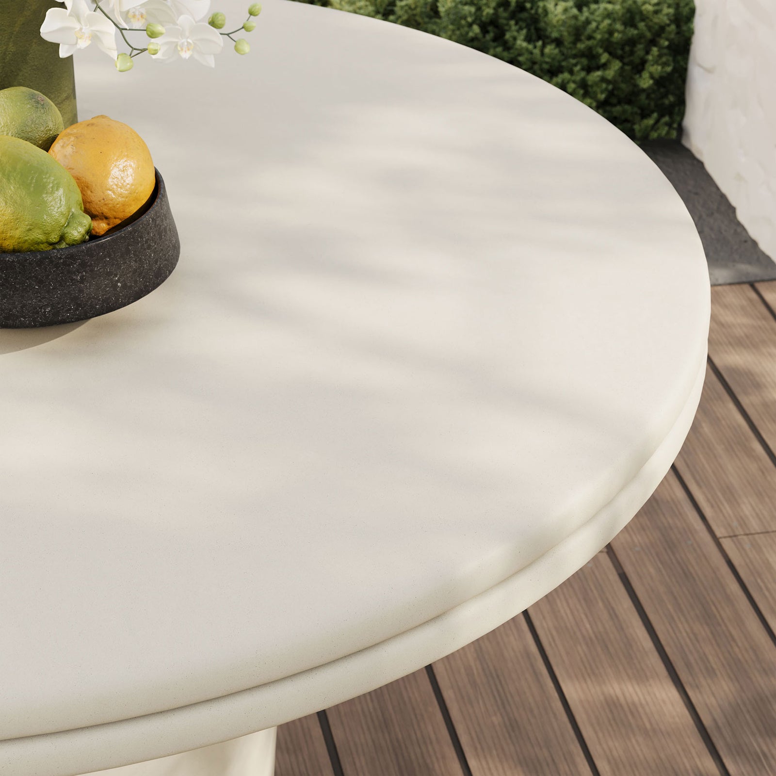 White concrete dining tabletop styled outdoors with fruit display, showing smooth surface and lip edge || EEI-7087-WHI || detail_room