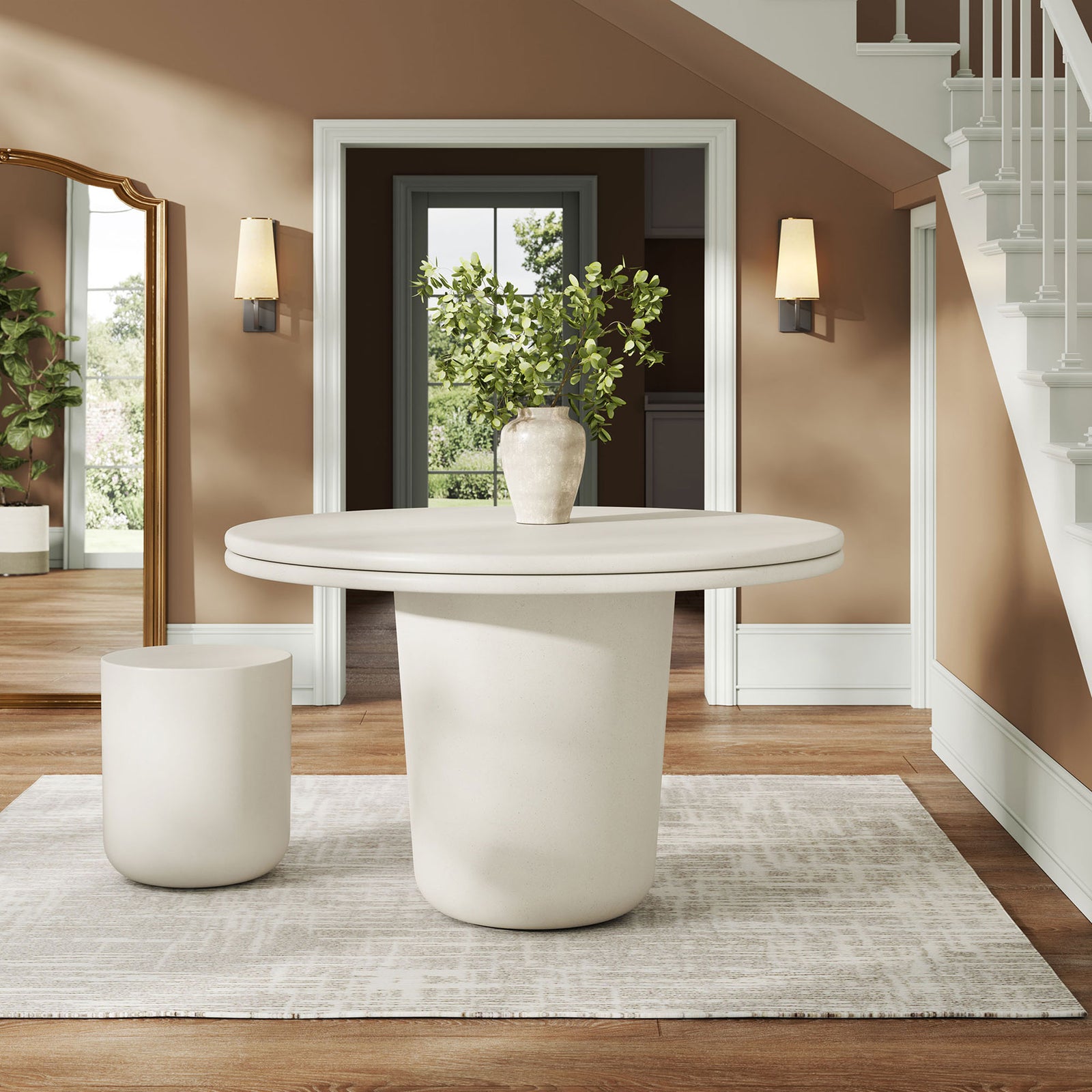 White concrete round dining table styled in an entryway with vase arrangement on neutral rug || EEI-7087-WHI || front_angle_room