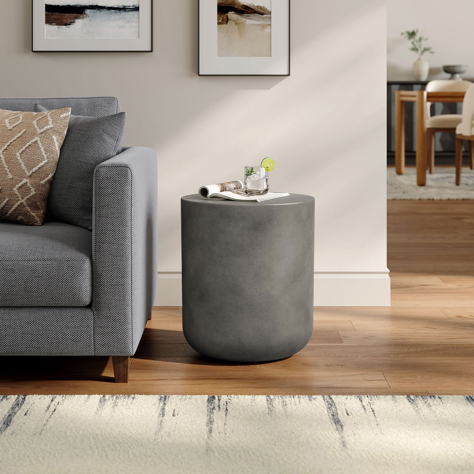 Brion gray concrete stool beside a sofa, adding sculptural modern style as a compact side table || EEI-7088-GRY || front_angle_room