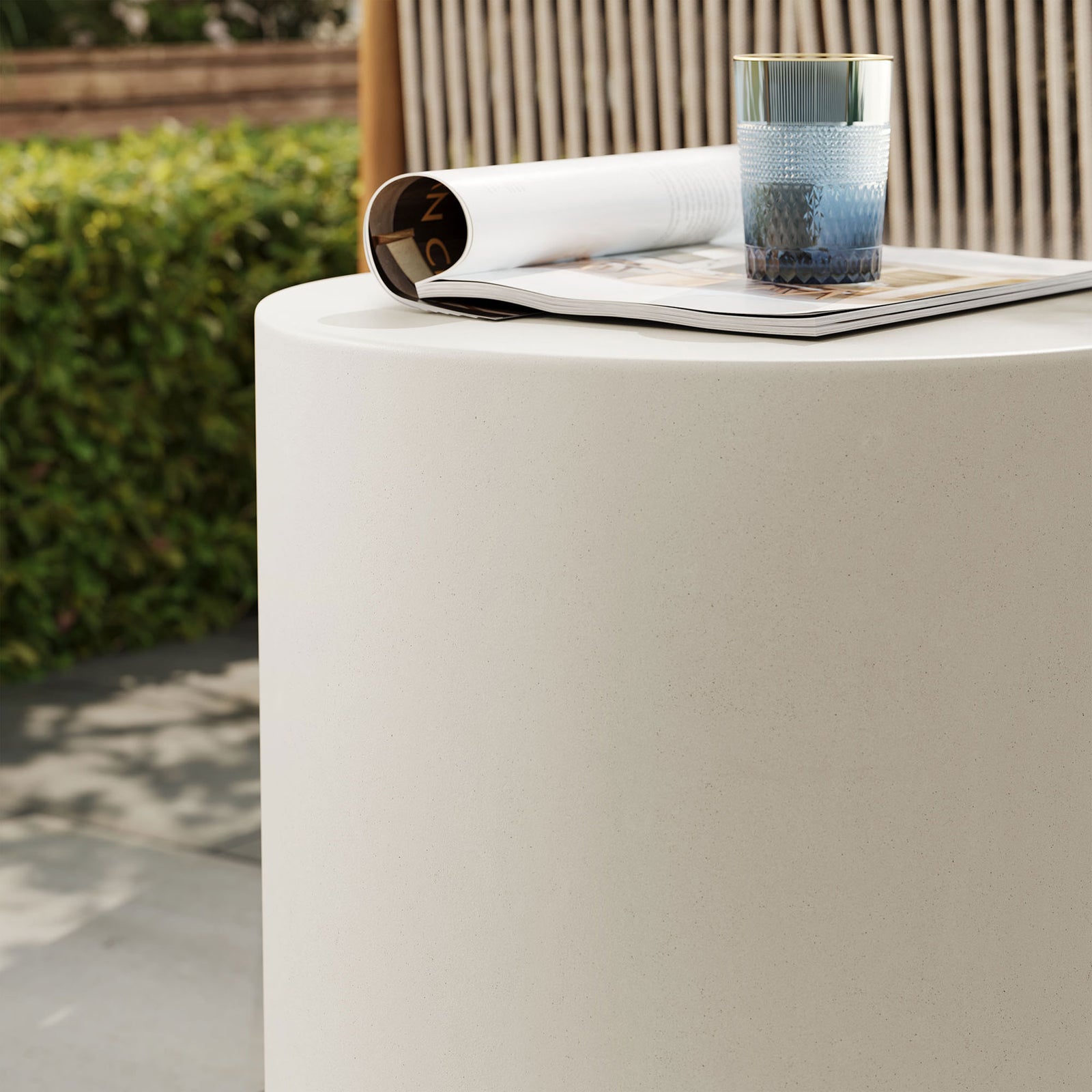Top of white concrete stool serving as a stable surface for drinks in a relaxed outdoor lounge || EEI-7088-WHI || detail_room