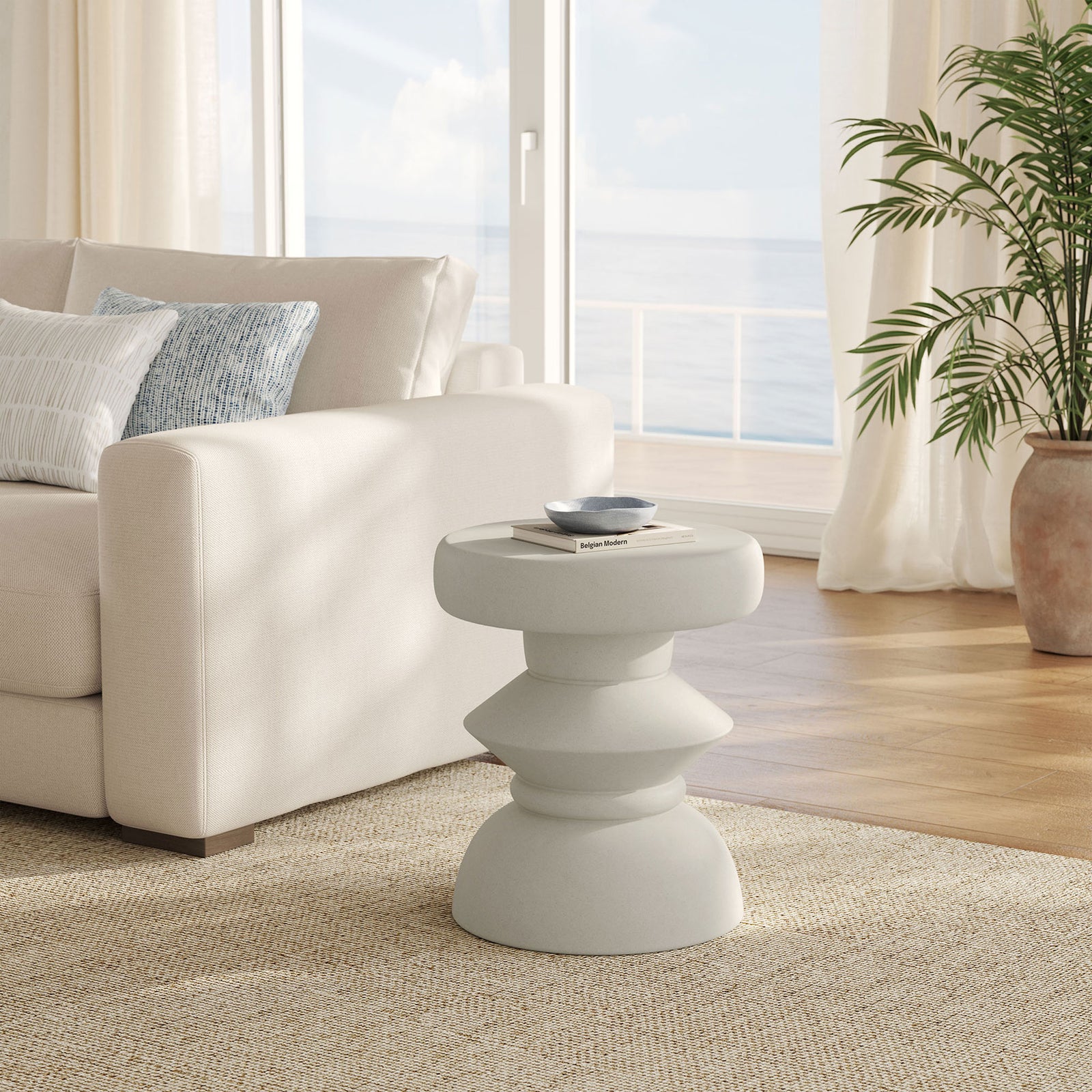 Light gray concrete side table beside a coastal sofa, adding sculptural style to the living room || EEI-7090-LGR || front_angle_room