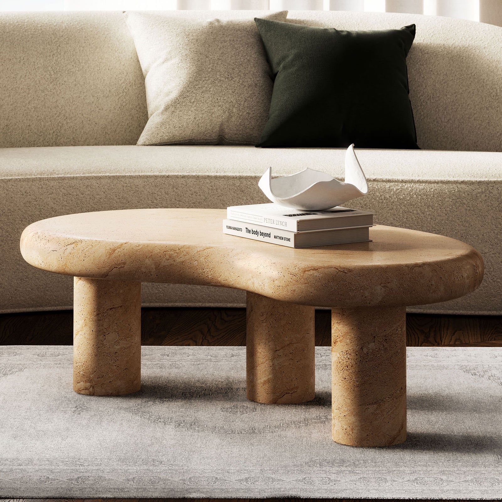 Low faux travertine coffee table brings sculptural interest and warm stone texture to a modern lounge || EEI-7093-TRV || front_angle_room