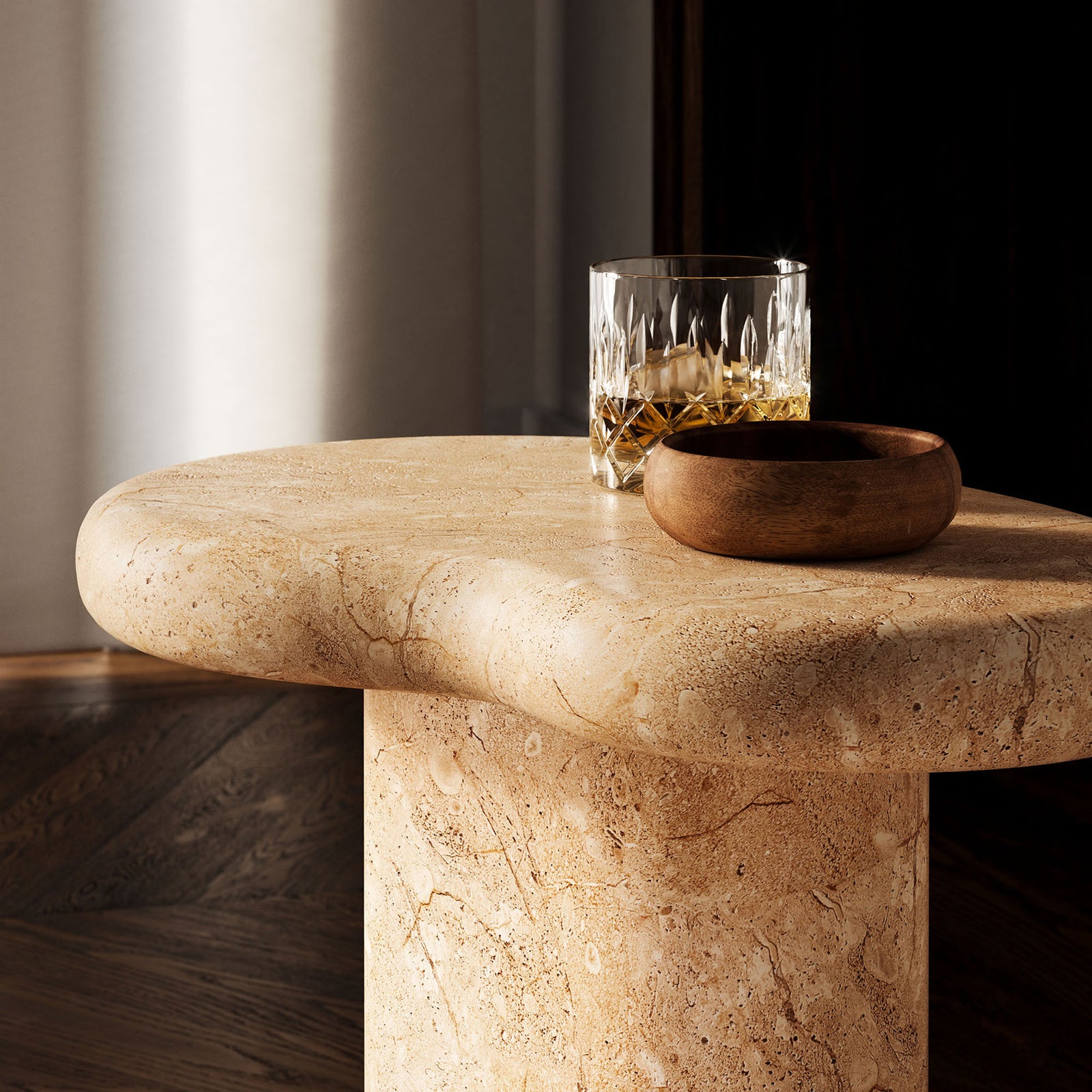 Warm travertine-look tabletop in a sophisticated interior, styled with a crystal glass and wooden bowl || EEI-7094-TRV || detail_room
