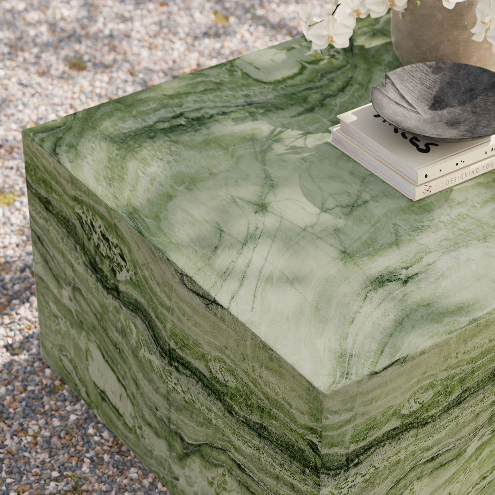 Outdoor scene highlights the green marble-look coffee table with decor, showcasing its durable concrete construction || EEI-7095-GRN || detail_room