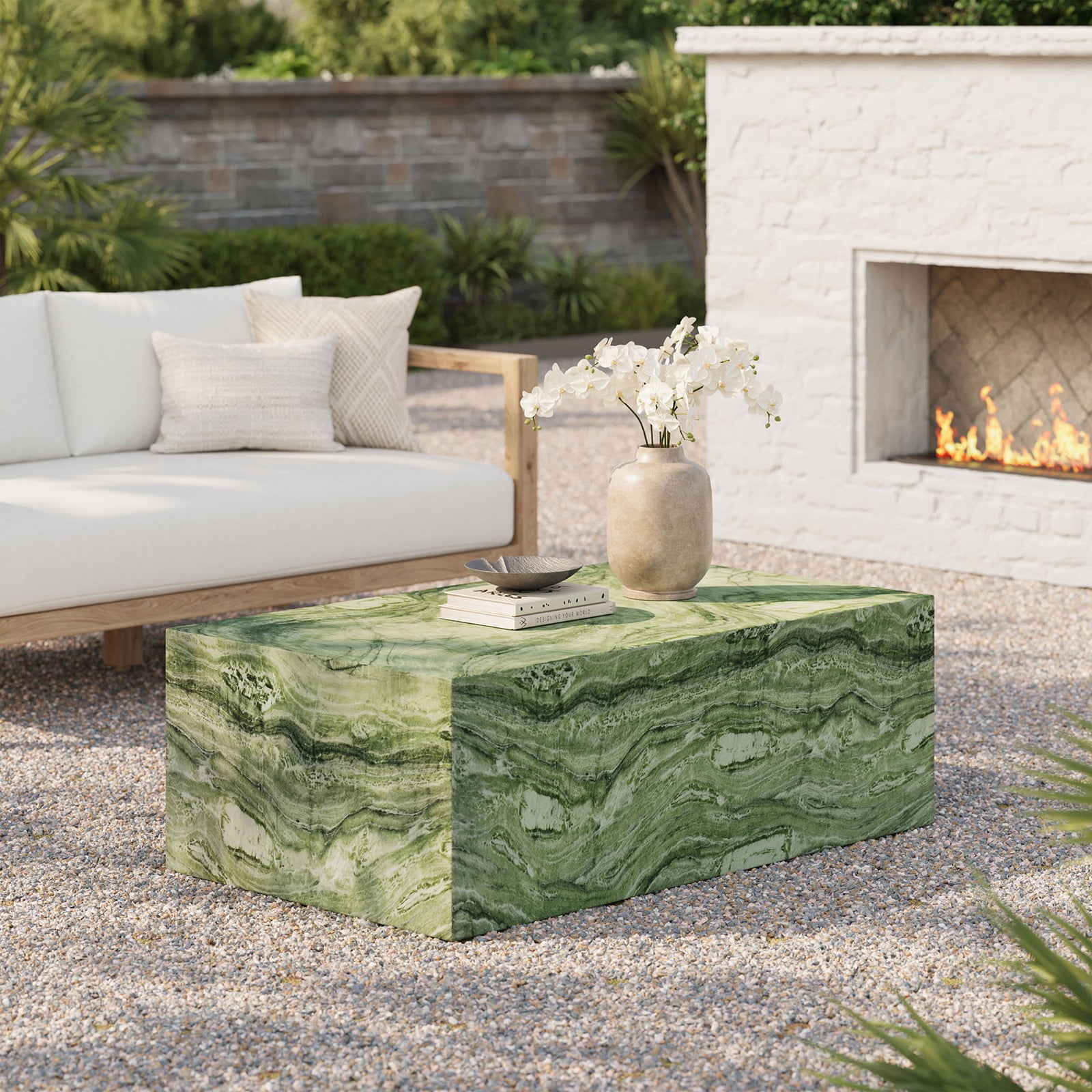 Green marble-look concrete coffee table completes a chic outdoor lounge beside neutral seating and a modern fireplace || EEI-7095-GRN || front_angle_room