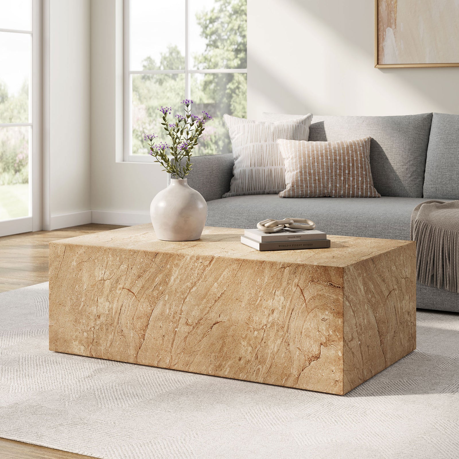 Jordana travertine-look concrete coffee table grounds a sunlit living room with its bold plinth silhouette || EEI-7095-TRV || front_angle_room