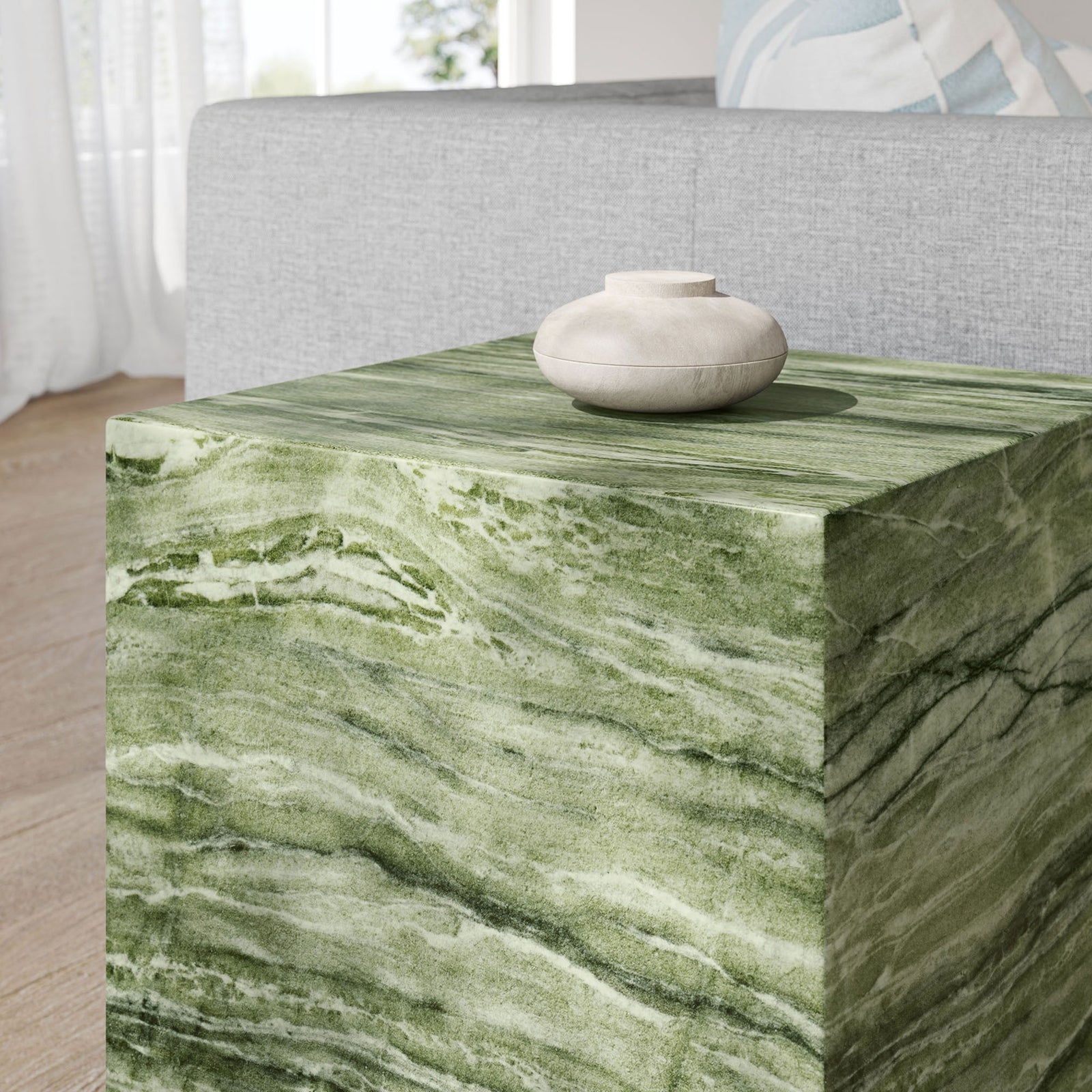Green marble-look side table styled in a bright living room with a minimalist ceramic accent bowl. || EEI-7096-GRN || detail_room