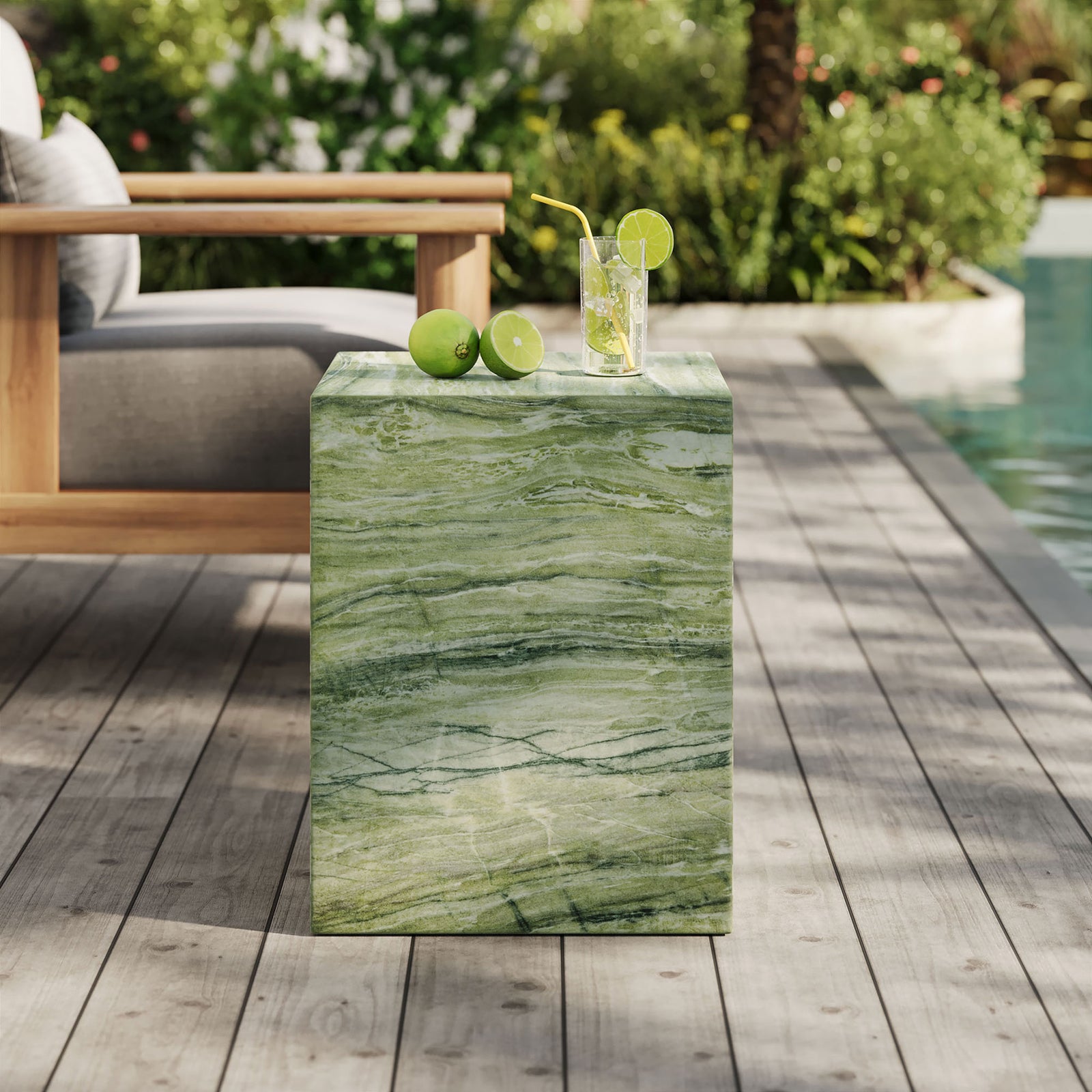 Green marble-look concrete side table beside a poolside lounge chair, ideal for drinks and decor. || EEI-7096-GRN || front_angle_room