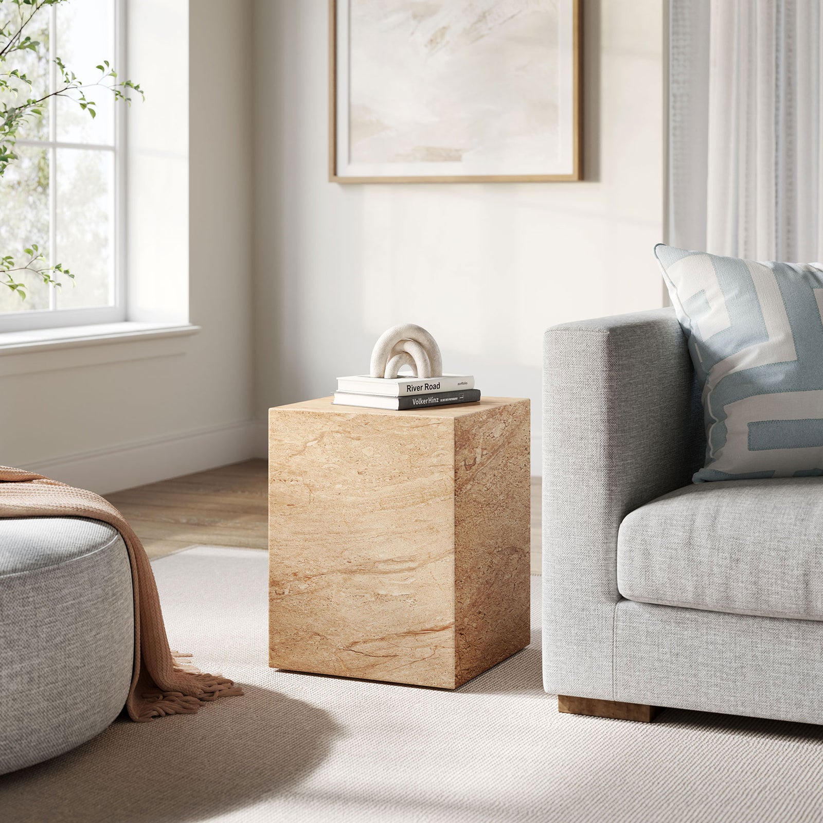Travertine-effect cube side table complementing a cozy neutral living room seating arrangement. || EEI-7096-TRV || front_angle_room