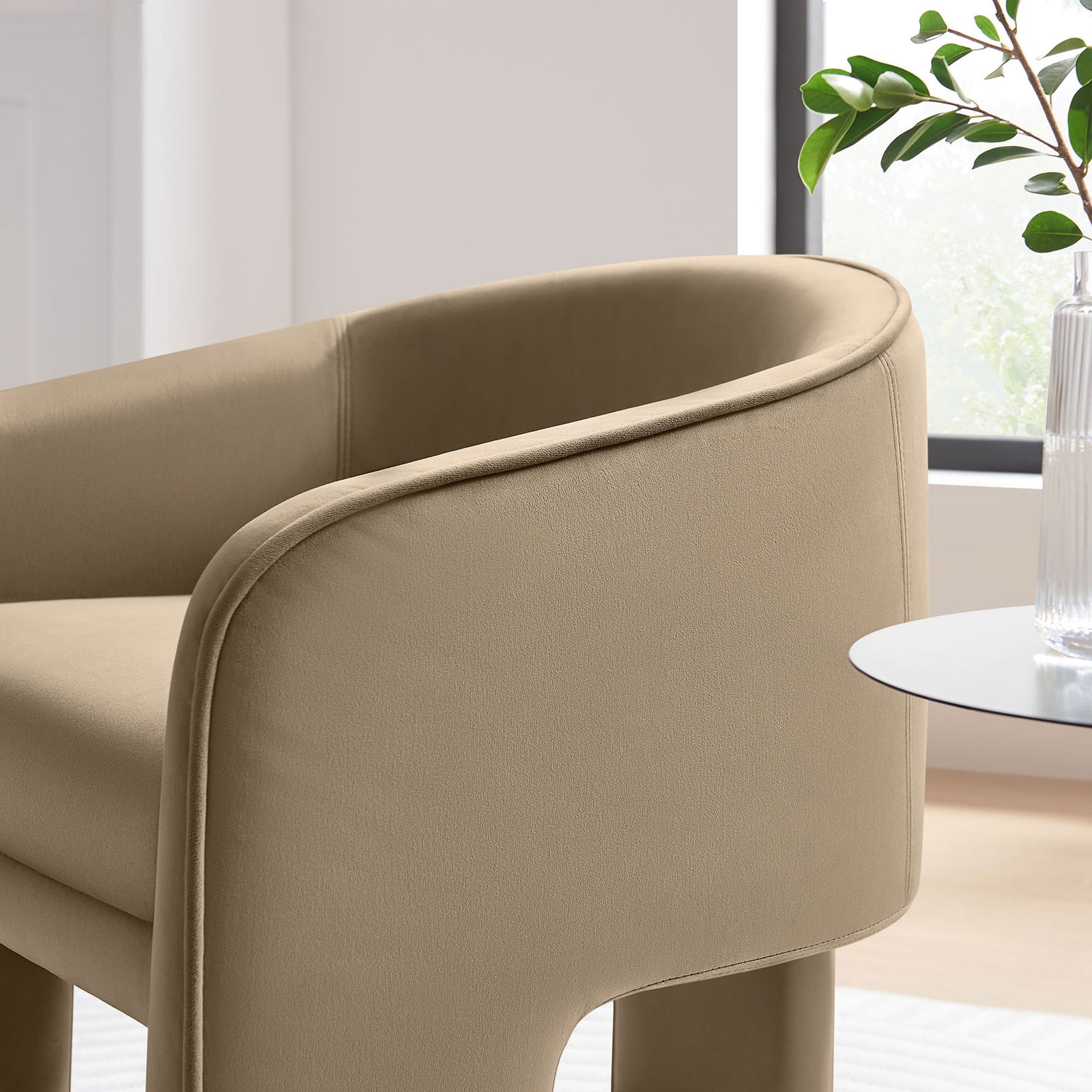 Soft velvet upholstery and smooth piping accentuate the chair's rounded arms and clean, contemporary profile || EEI-7102-TAU || detail_room