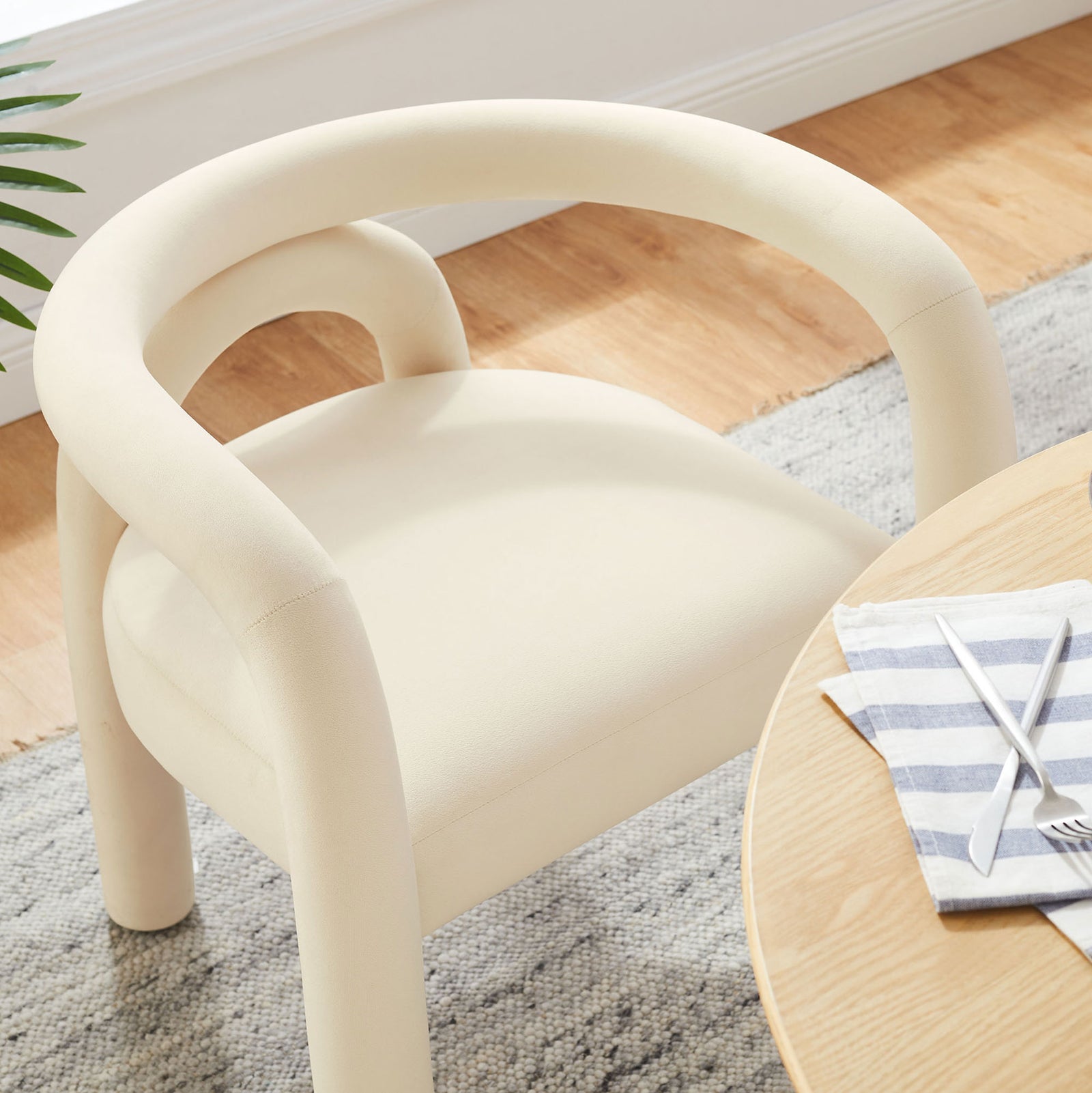 Porcelain velvet barrel dining chair styled at a round table in a bright modern dining room || EEI-7104-POR || front_room