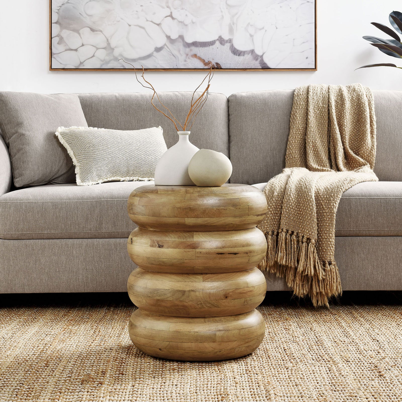 Sculptural stacked mango wood side table styled with ceramic vases in a cozy living room || EEI-7106-NAT || front_room