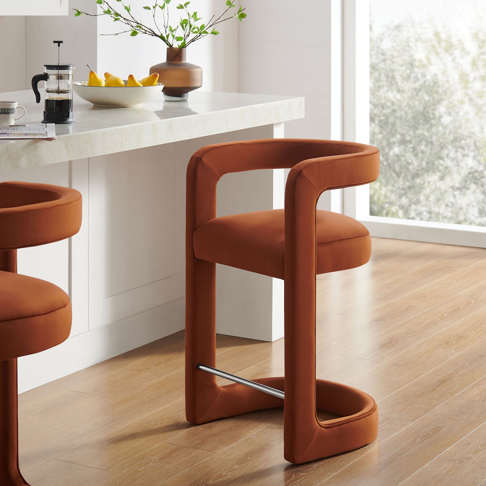Modern counter stool in warm rust velvet with graceful curves and a gleaming footrest || EEI-7107-RUS || front_angle_room