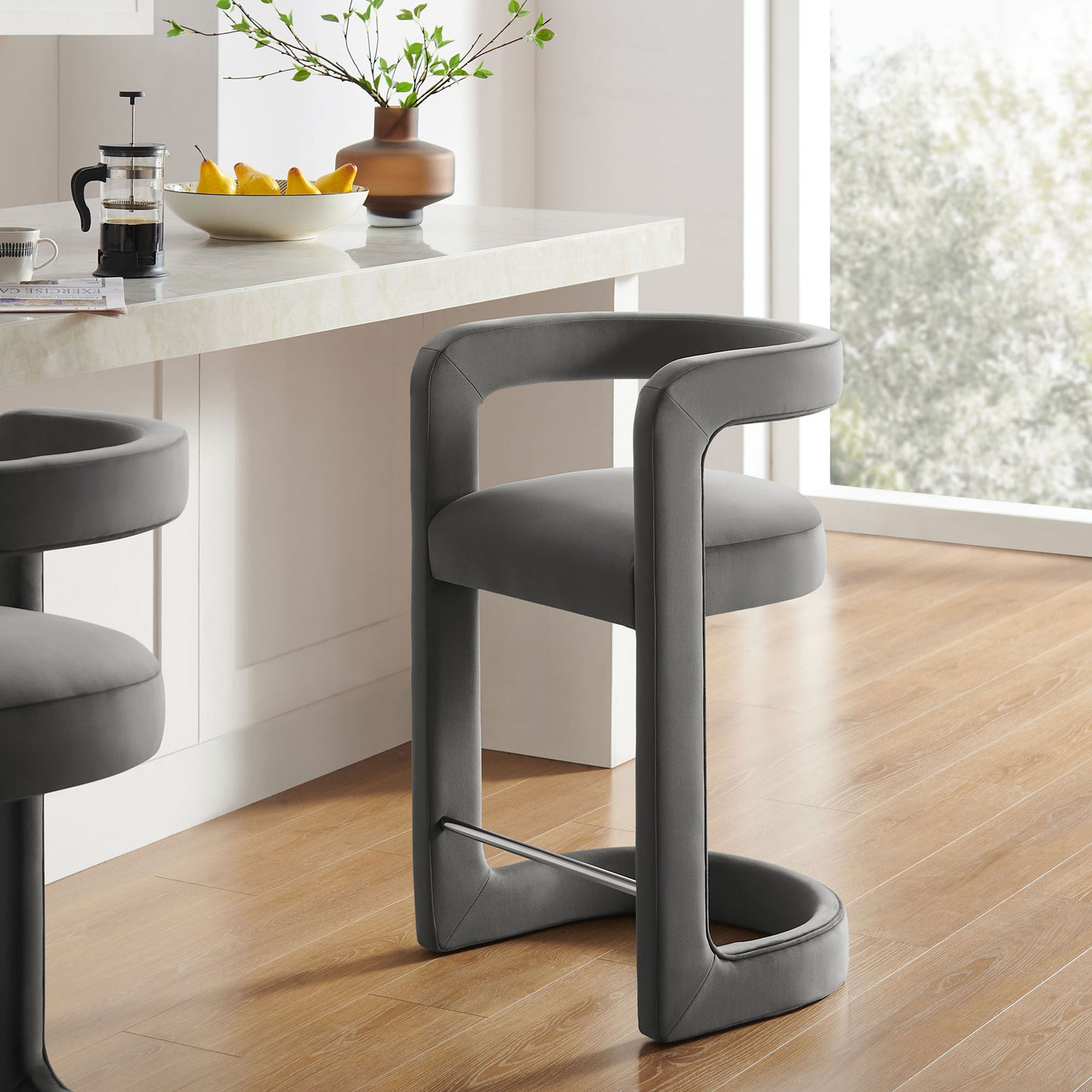 Modern counter stool elevates the kitchen with its arched base and airy open-back design || EEI-7107-STG || front_angle_room