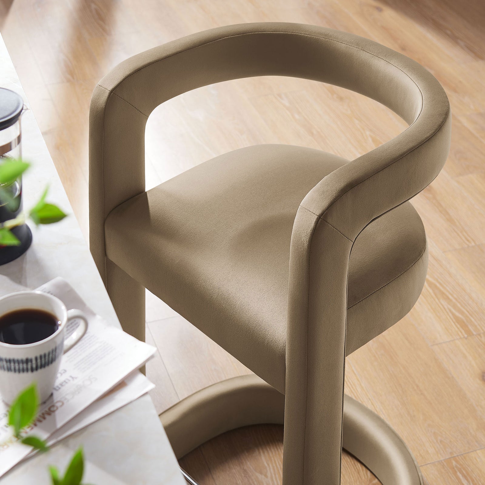 Plush taupe velvet seat and curved backrest beside a bright kitchen counter || EEI-7107-TAU || detail_room