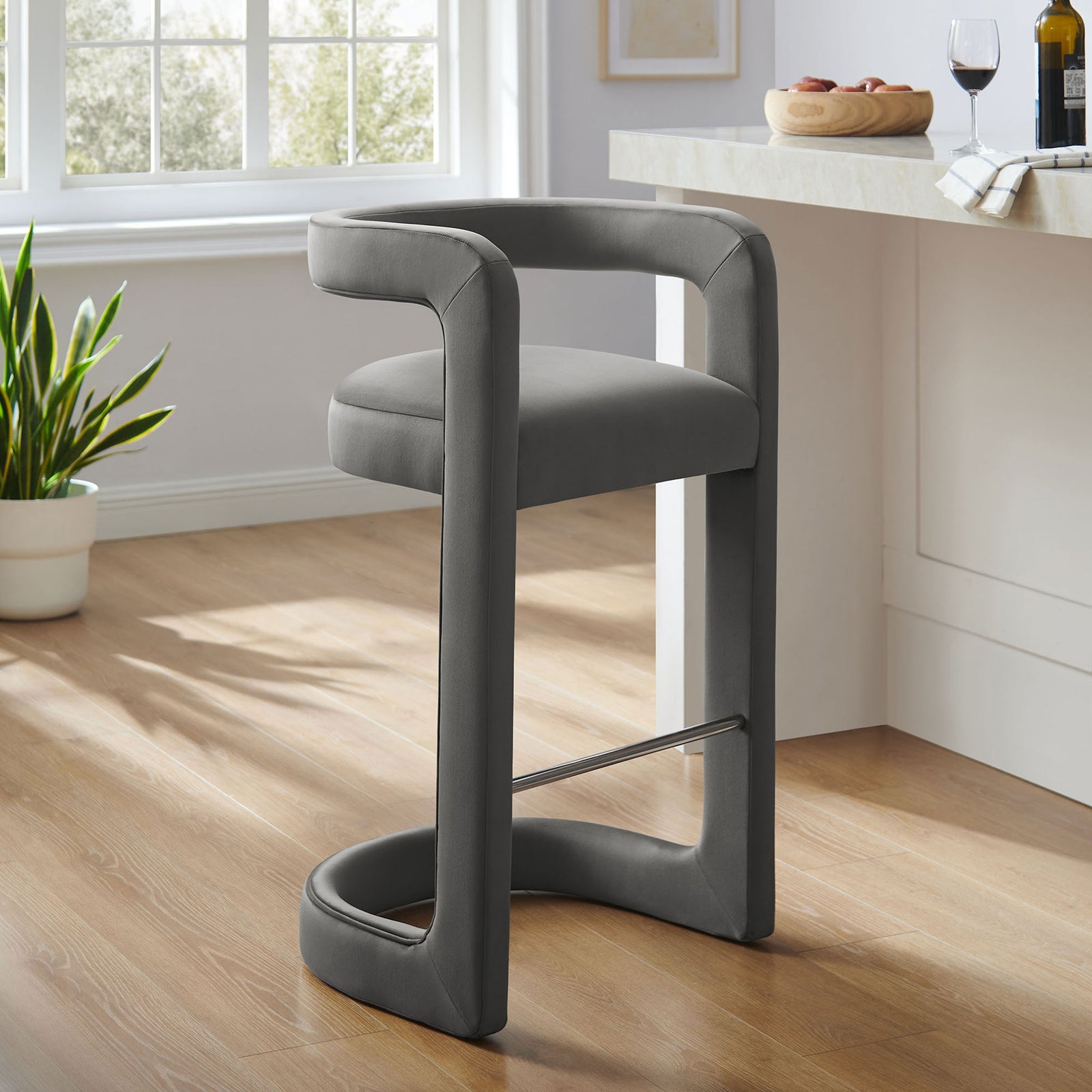 Modern bar stool refreshes the kitchen with its arched base and minimalist silhouette || EEI-7108-STG || front_angle_room