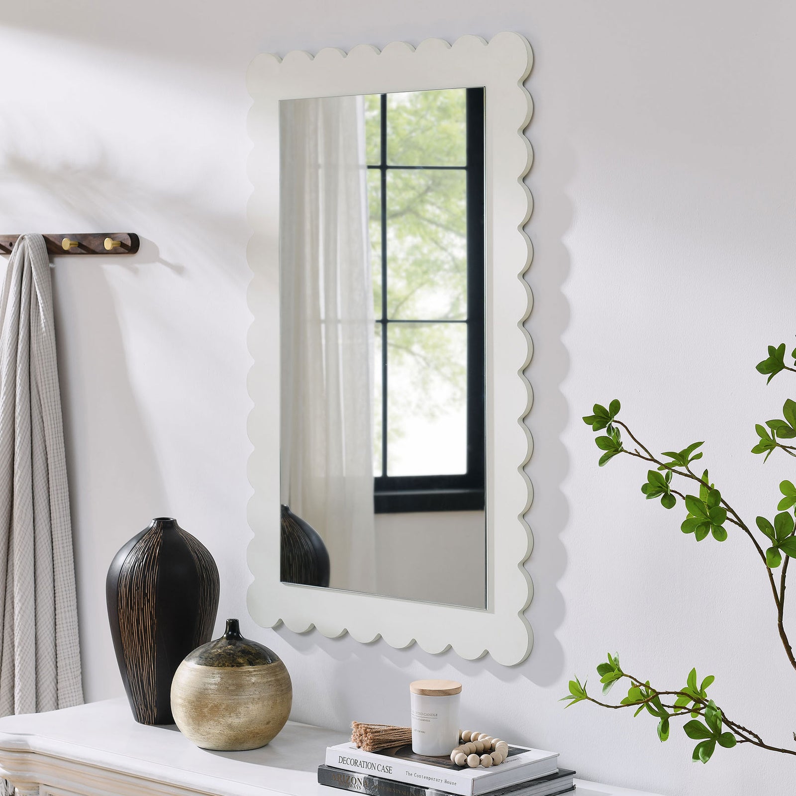 White scalloped mirror styled above a console table for everyday entryway charm || EEI-7116-WHI || front_angle_room