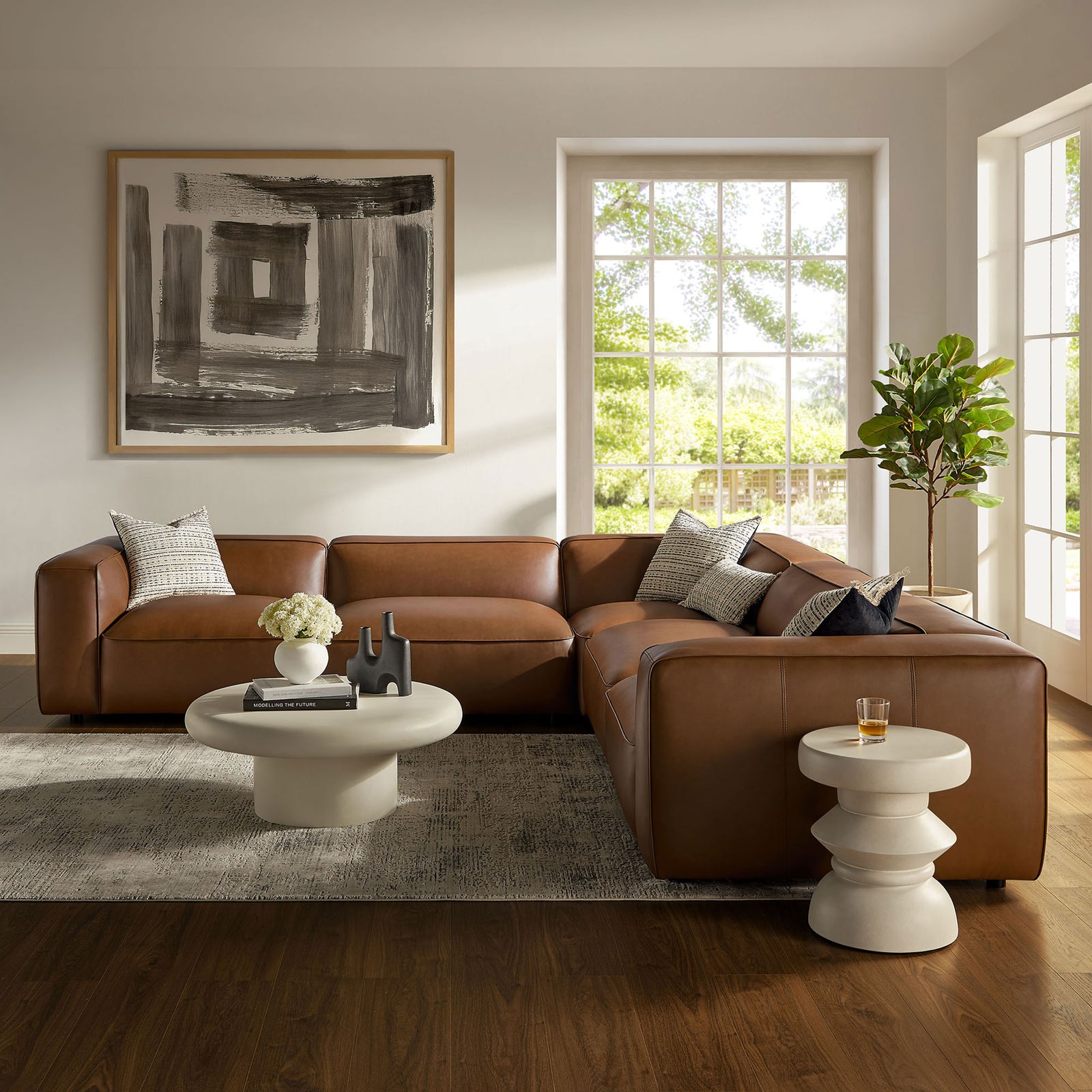 Coffee vegan leather Auren sectional styled in a bright living room with rug, art, and modern decor || EEI-7129-COF || front_angle_room