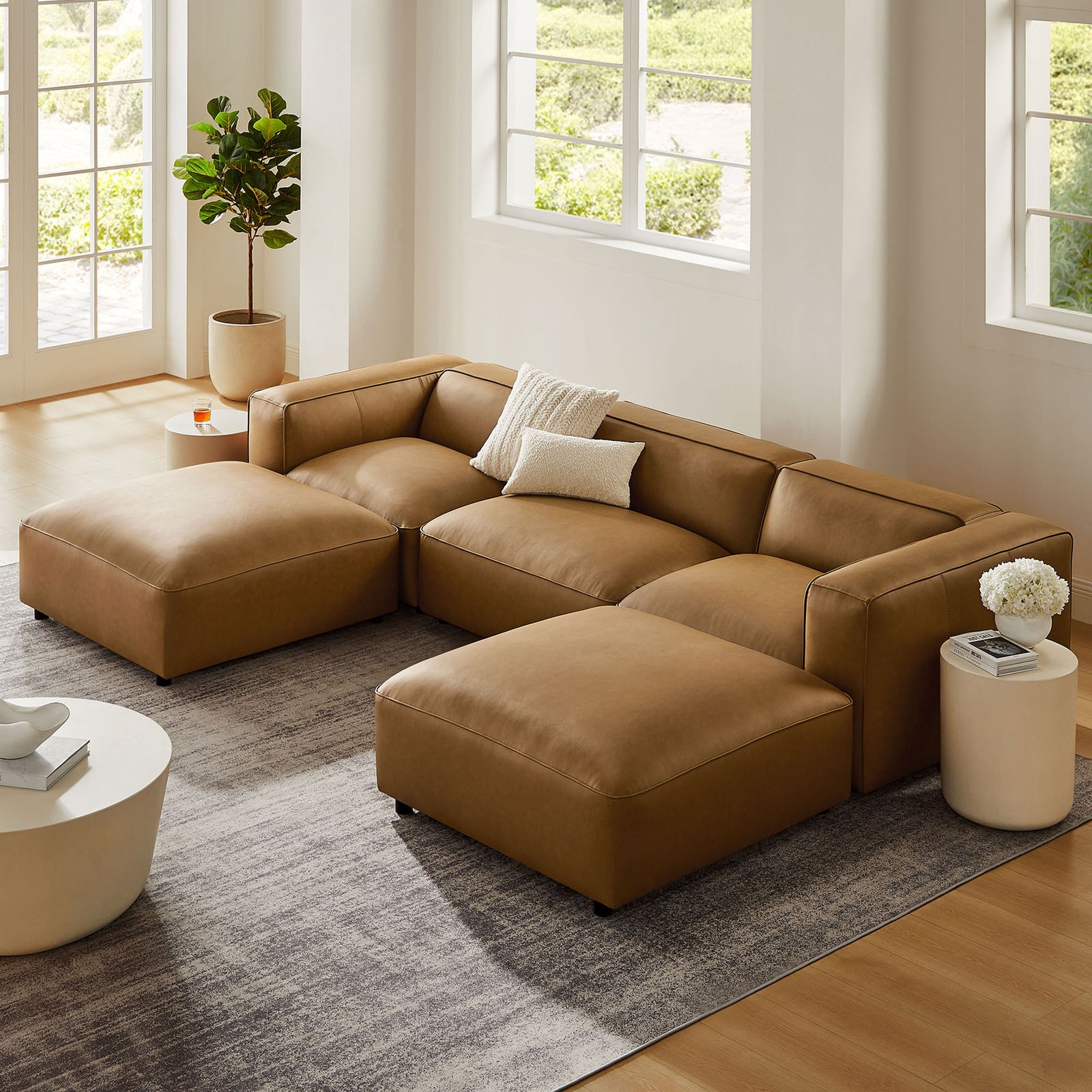 Spacious camel vegan leather modular U-shaped sectional sofa arranged in a bright, airy living room || EEI-7131-CAM || front_angle_room