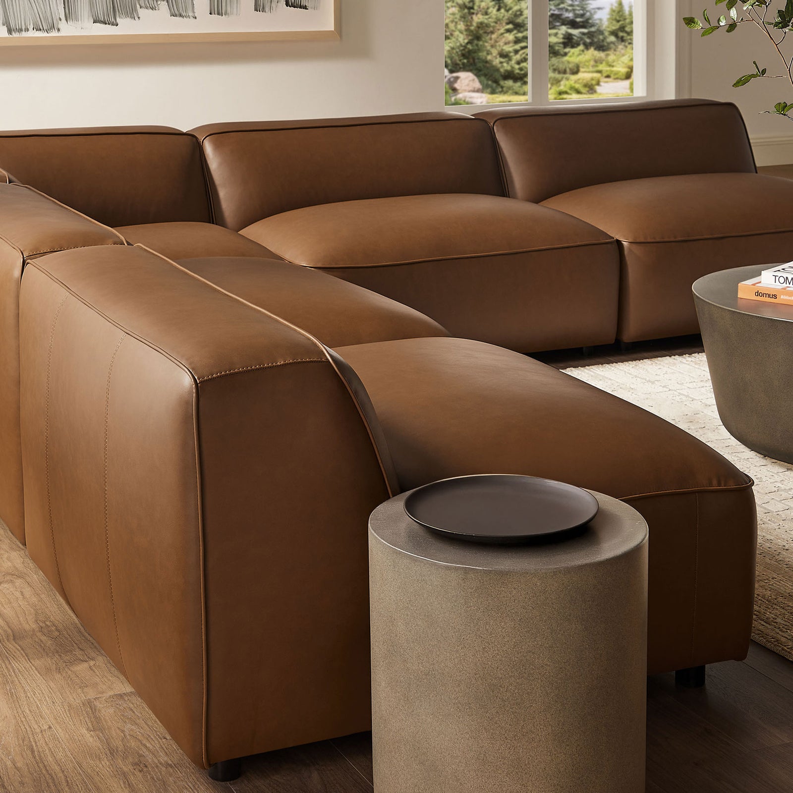 Auren modular sofa in coffee vegan leather with tailored stitching and generously padded low-slung cushions. || EEI-7133-COF || detail_room