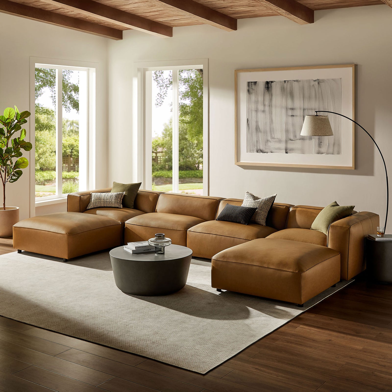 Camel vegan leather Auren modular sectional arranged in a spacious living room with rug and coffee table || EEI-7134-CAM || front_angle_room
