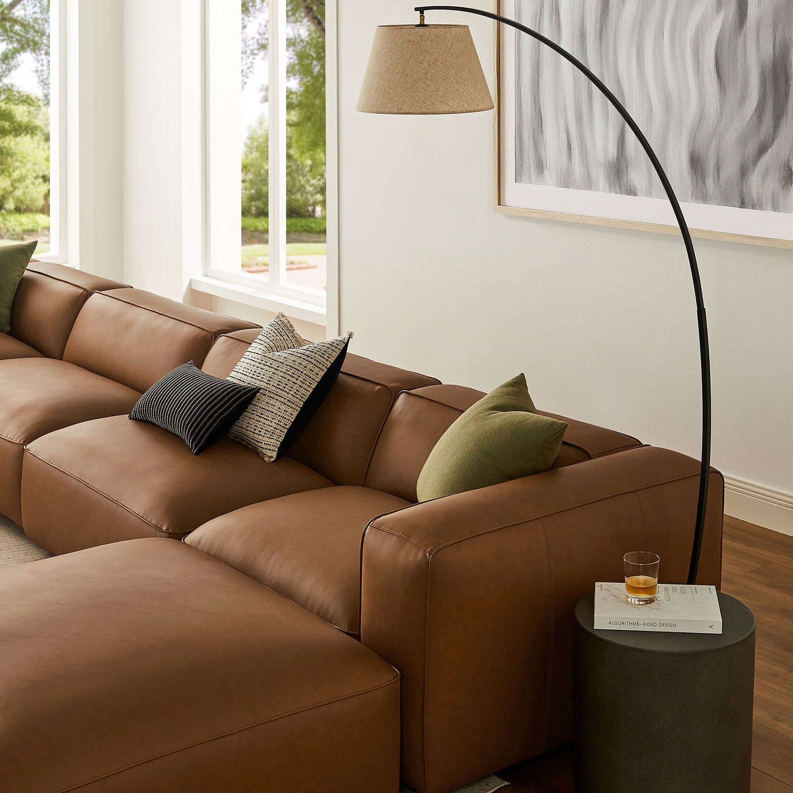 Coffee vegan leather sectional with plush cushions styled with accent pillows in a bright living room || EEI-7134-COF || detail_room