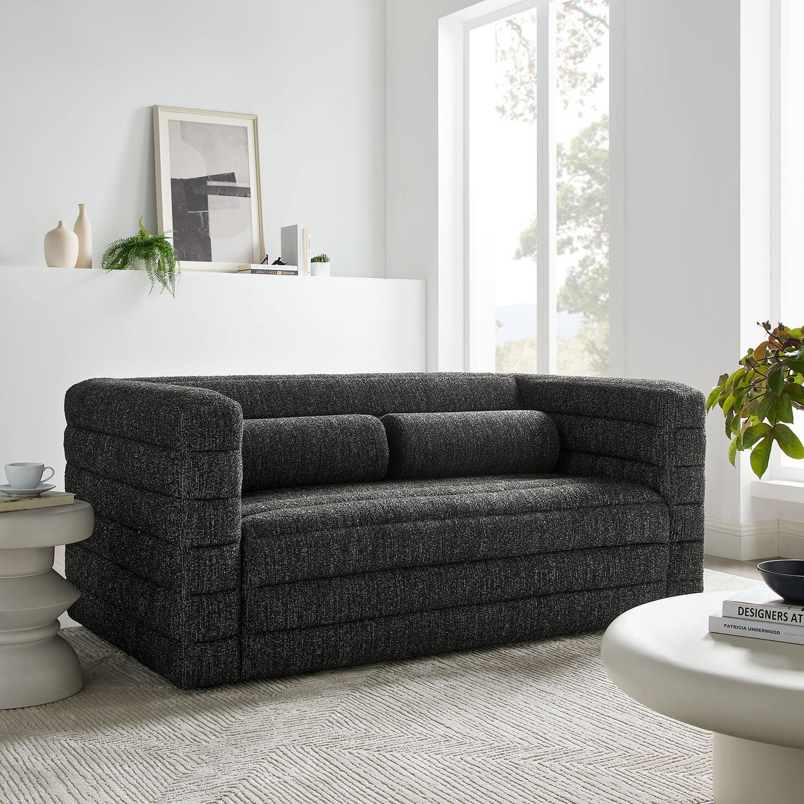 Channel-tufted charcoal loveseat styled with minimalist decor for a cozy gathering spot || EEI-7137-CHA || front_angle_room