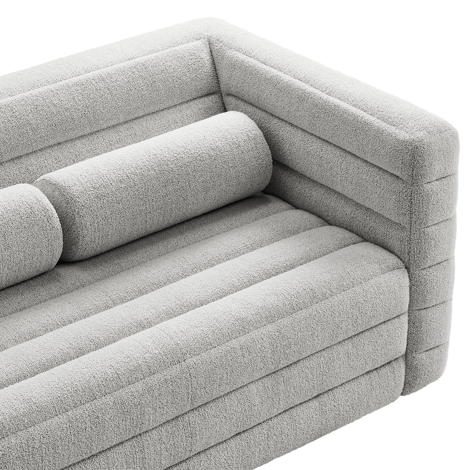 Close view of the Relle loveseat arm and bolster pillow, highlighting the plush boucle texture and channel design. || EEI-7137-NPT || detail_studio