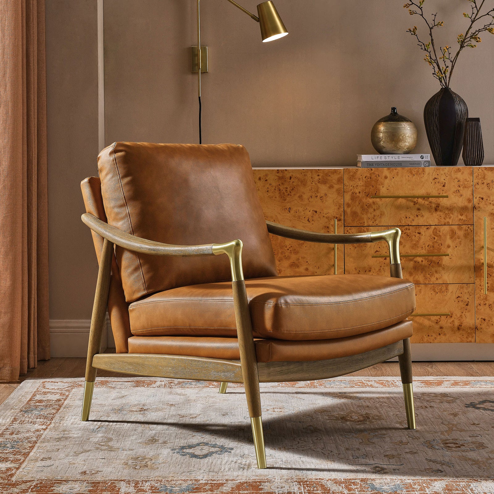 Statement accent chair pairs tan leather-look cushions with walnut wood and brass for modern warmth || EEI-7138-TAN-WAL || front_angle_room