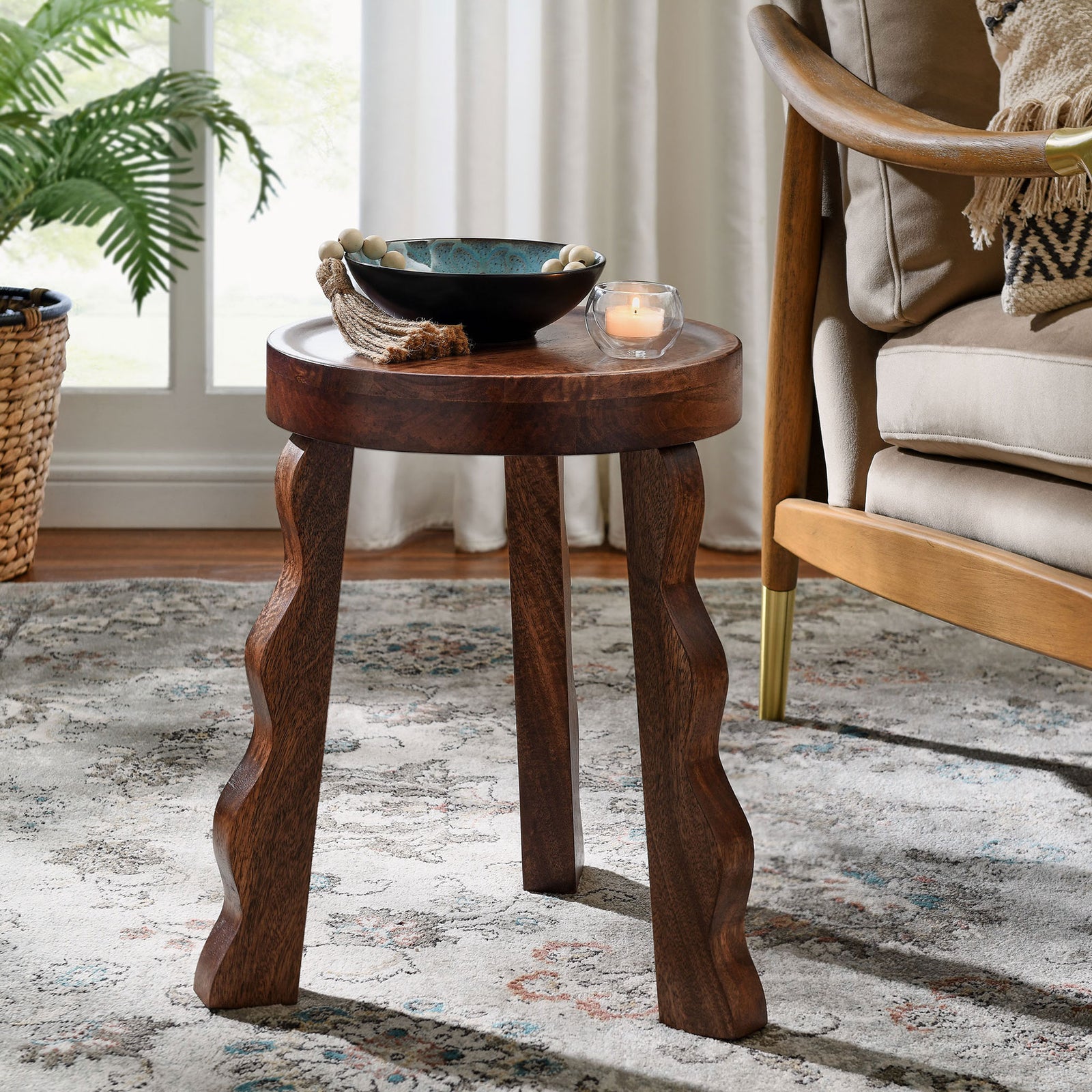 Wood stool used as a side table beside an armchair in a cozy living room || EEI-7140-WAL || front_angle_room