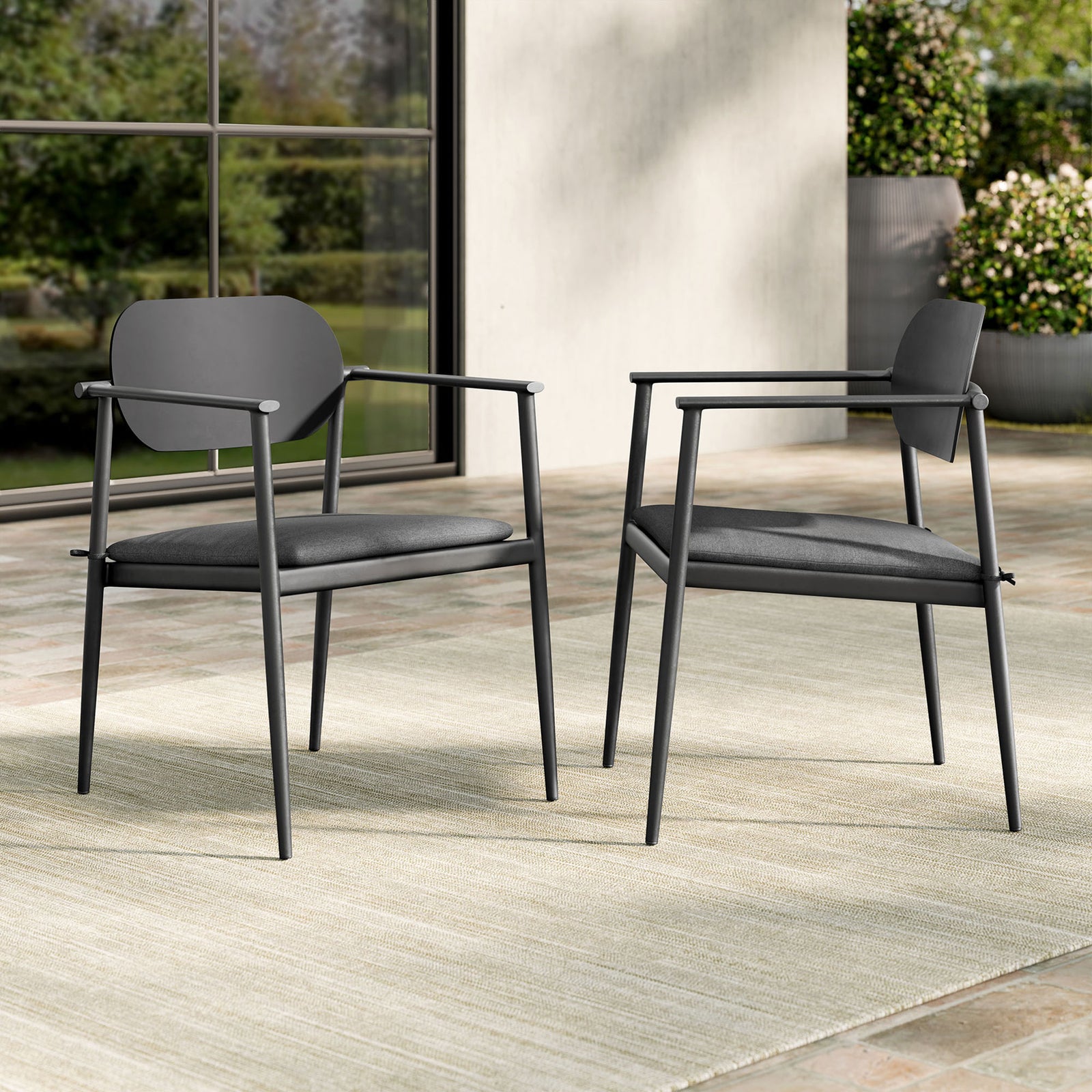 Set of two charcoal patio armchairs with gray cushions arranged on an outdoor terrace for relaxed dining || EEI-7148-CHA-CHA || front_angle_multi_room