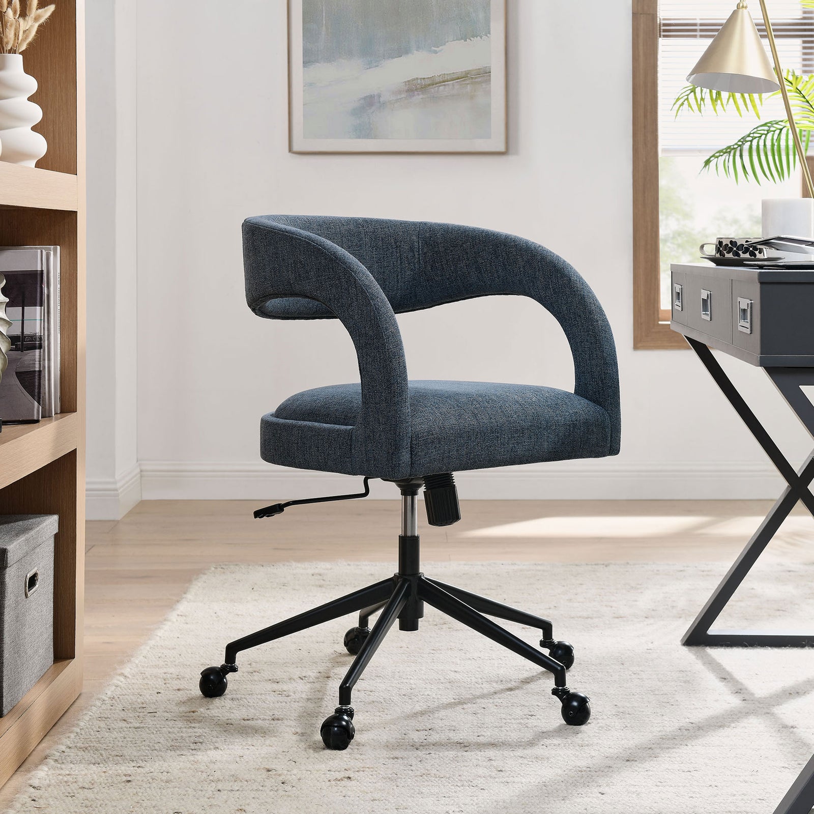 Barrel back office chair adding tailored comfort to a contemporary home workspace. || EEI-7149-SLB || front_angle_room