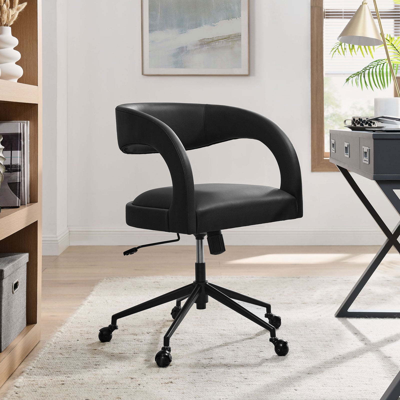 Pinnacle black vegan leather office chair adding sleek comfort to a bright home workspace. || EEI-7150-BLK || front_room