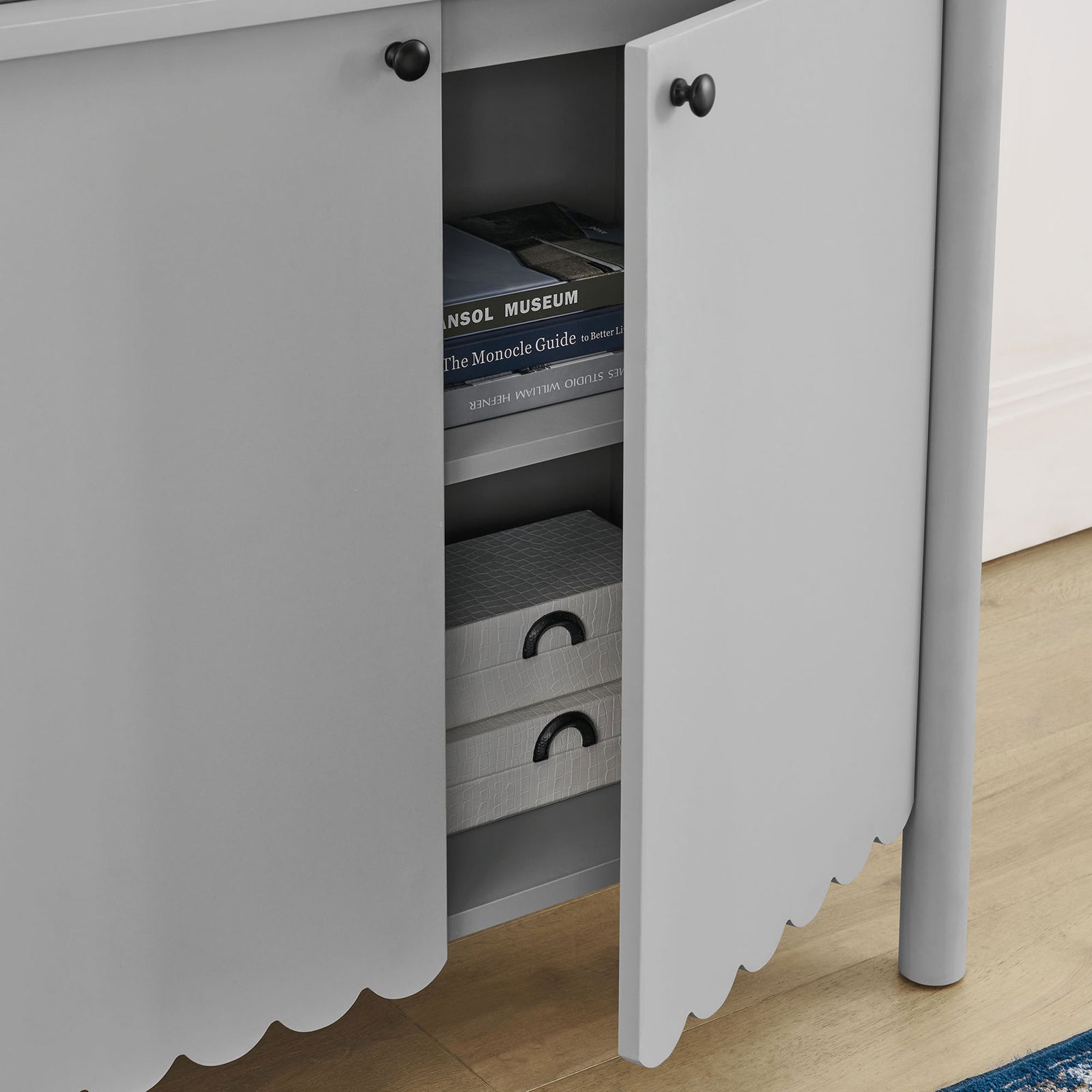Adjustable interior shelf neatly organizes books and storage boxes behind the cabinet doors || EEI-7152-LGR || storage_open_room
