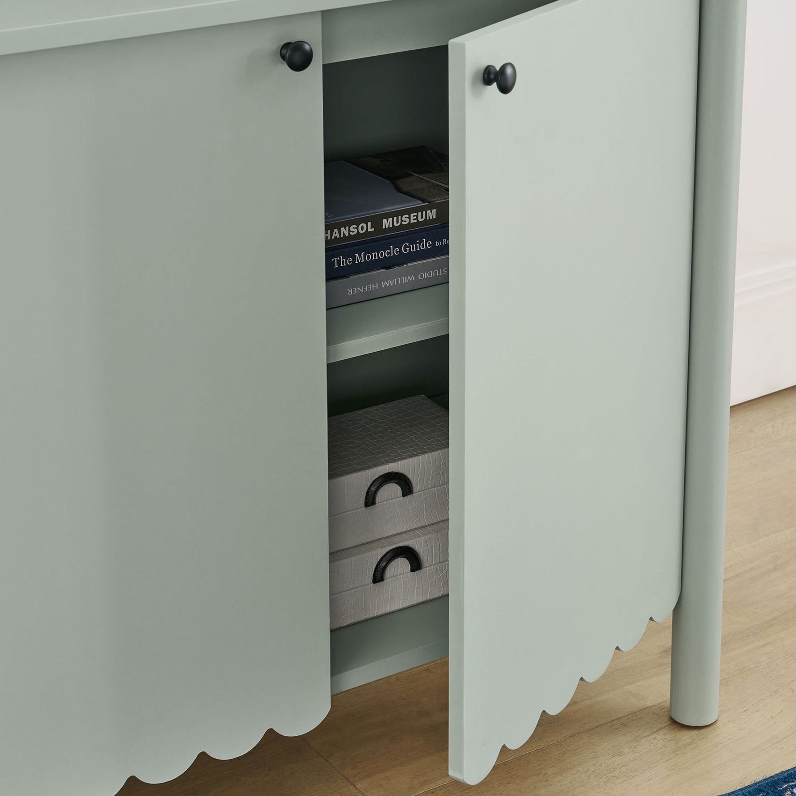 Styled cabinet in a modern room with door open to show organized storage for books and decor || EEI-7152-SGE || storage_open_room