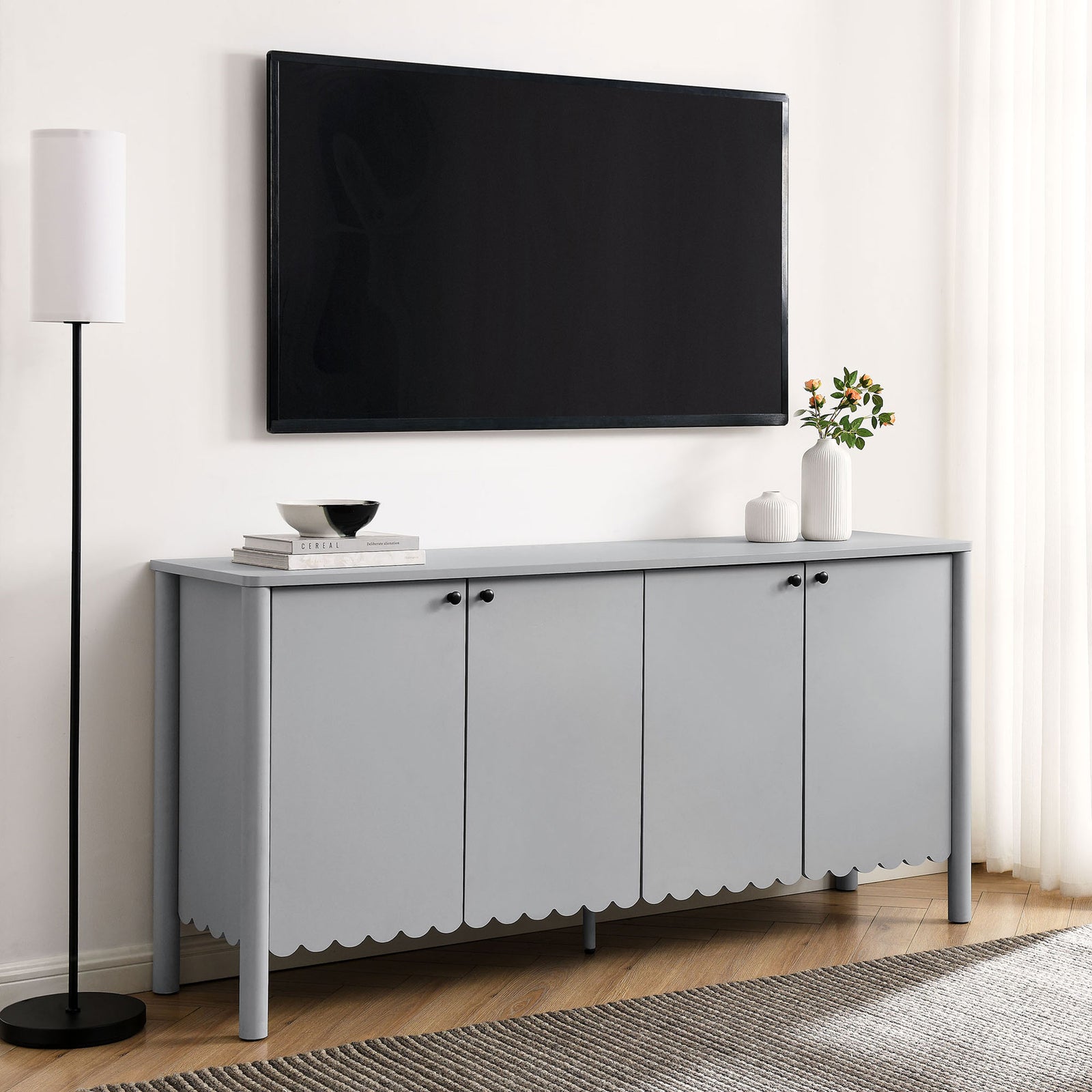 Light gray Emmeline sideboard used as a sleek media console beneath a wall mounted TV in a modern living room || EEI-7153-LGR || front_angle_room