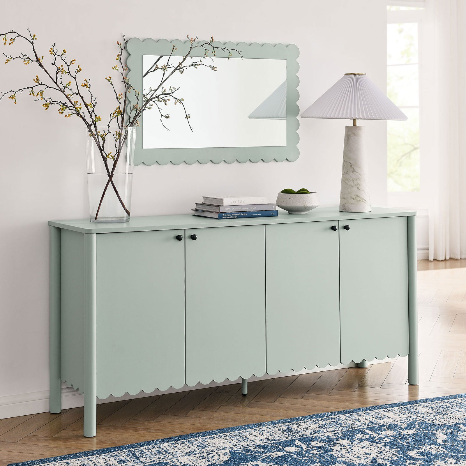 Sage Emmeline sideboard styled with mirror, lamp, and decor in airy room || EEI-7153-SGE || front_angle_room
