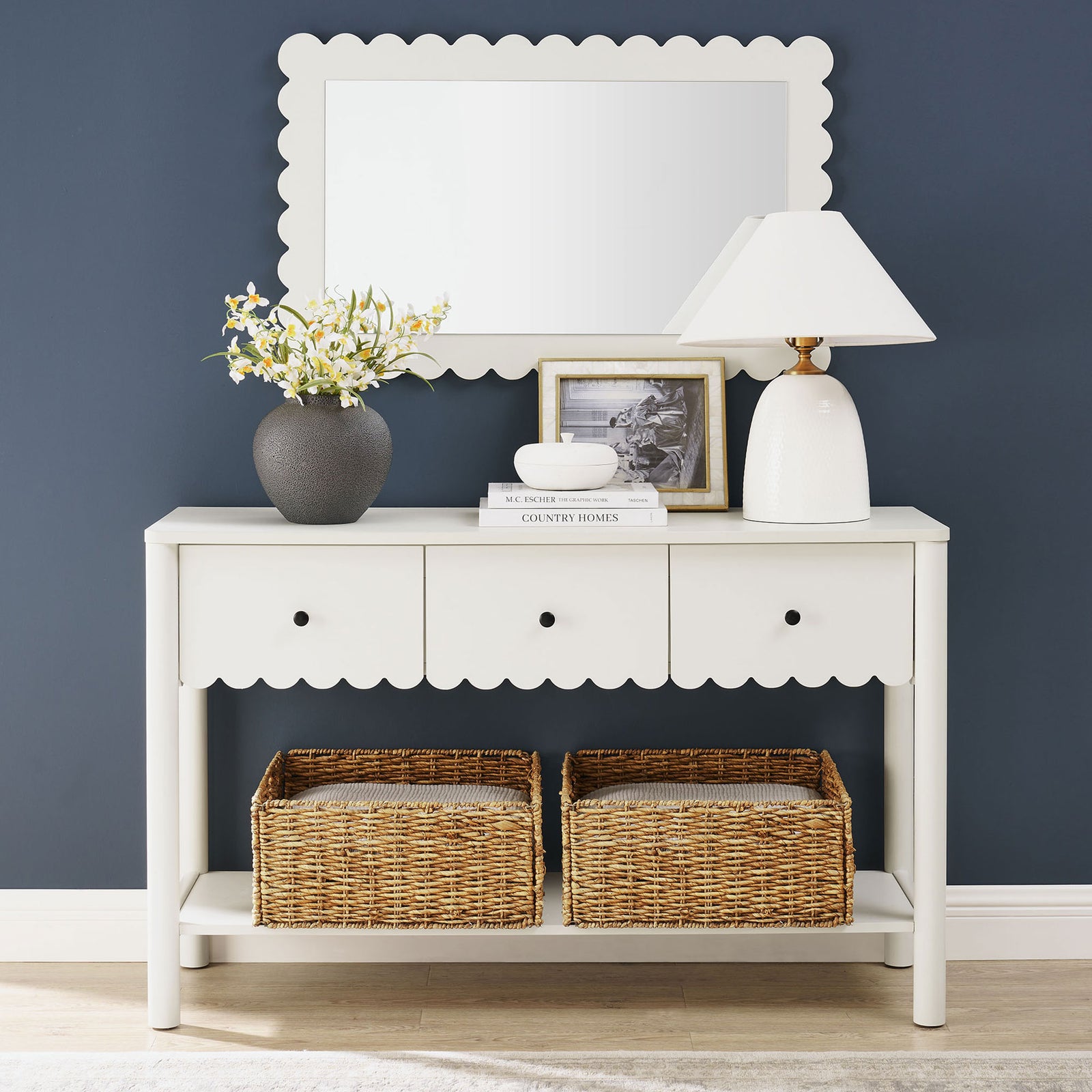 Styled entryway look highlights the console's airy lower shelf and charming scalloped detailing. || EEI-7154-WHI || front_room