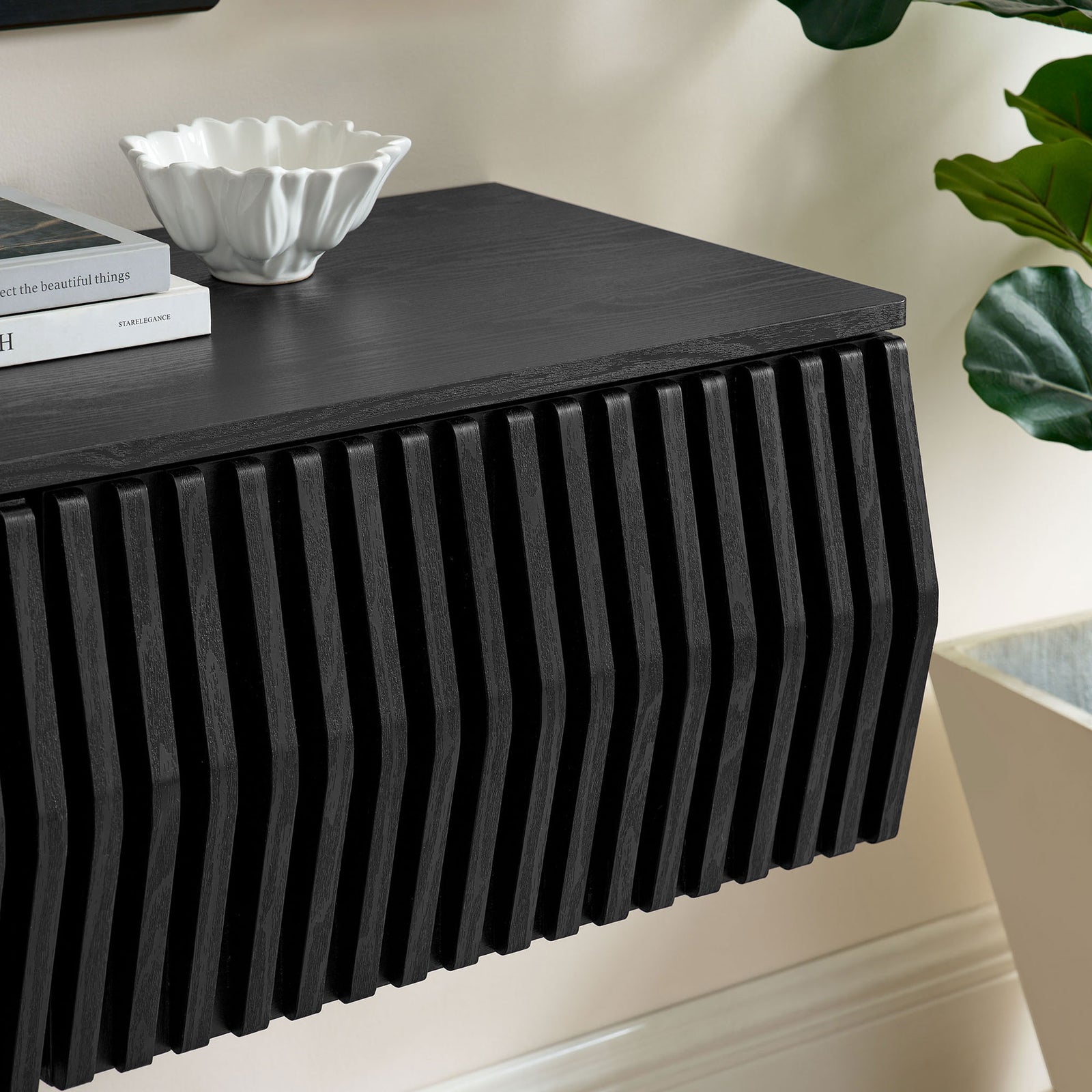 Black TV cabinet top styled with modern decor accents above the sculpted slatted front || EEI-7164-BLK || detail_room